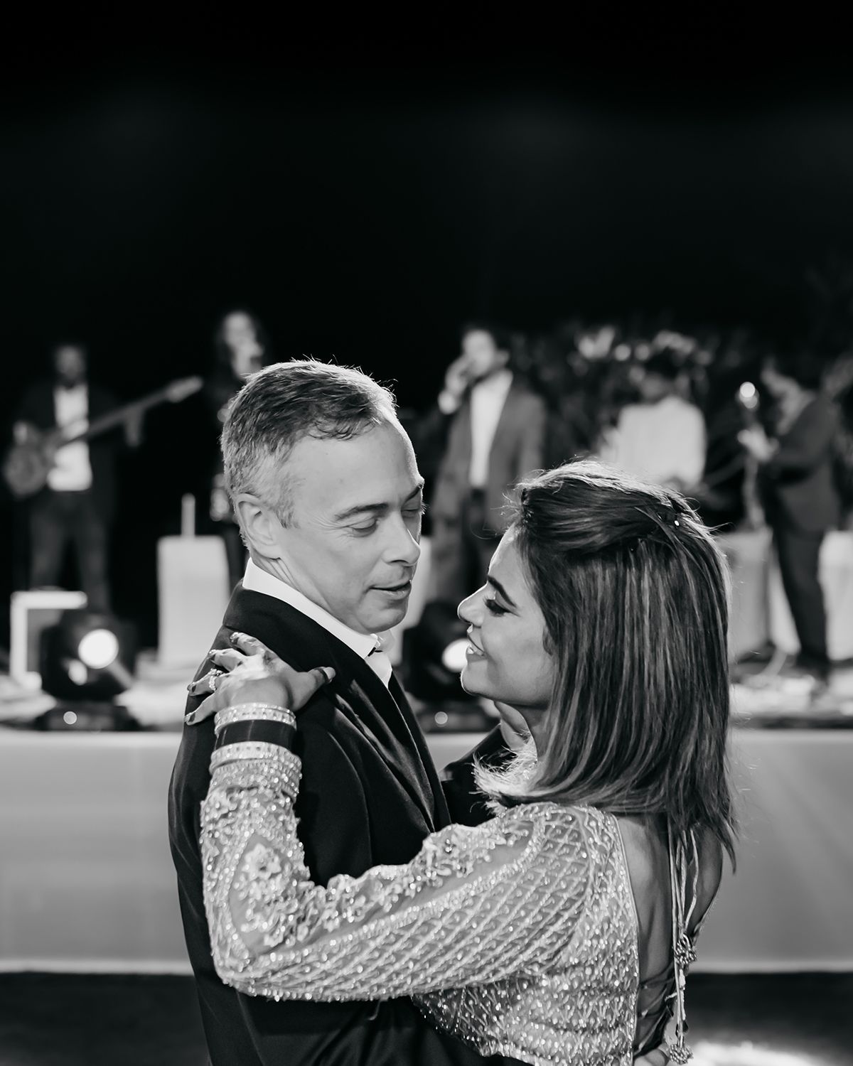 An intimate dance moment captured in black and white at an evening celebration.