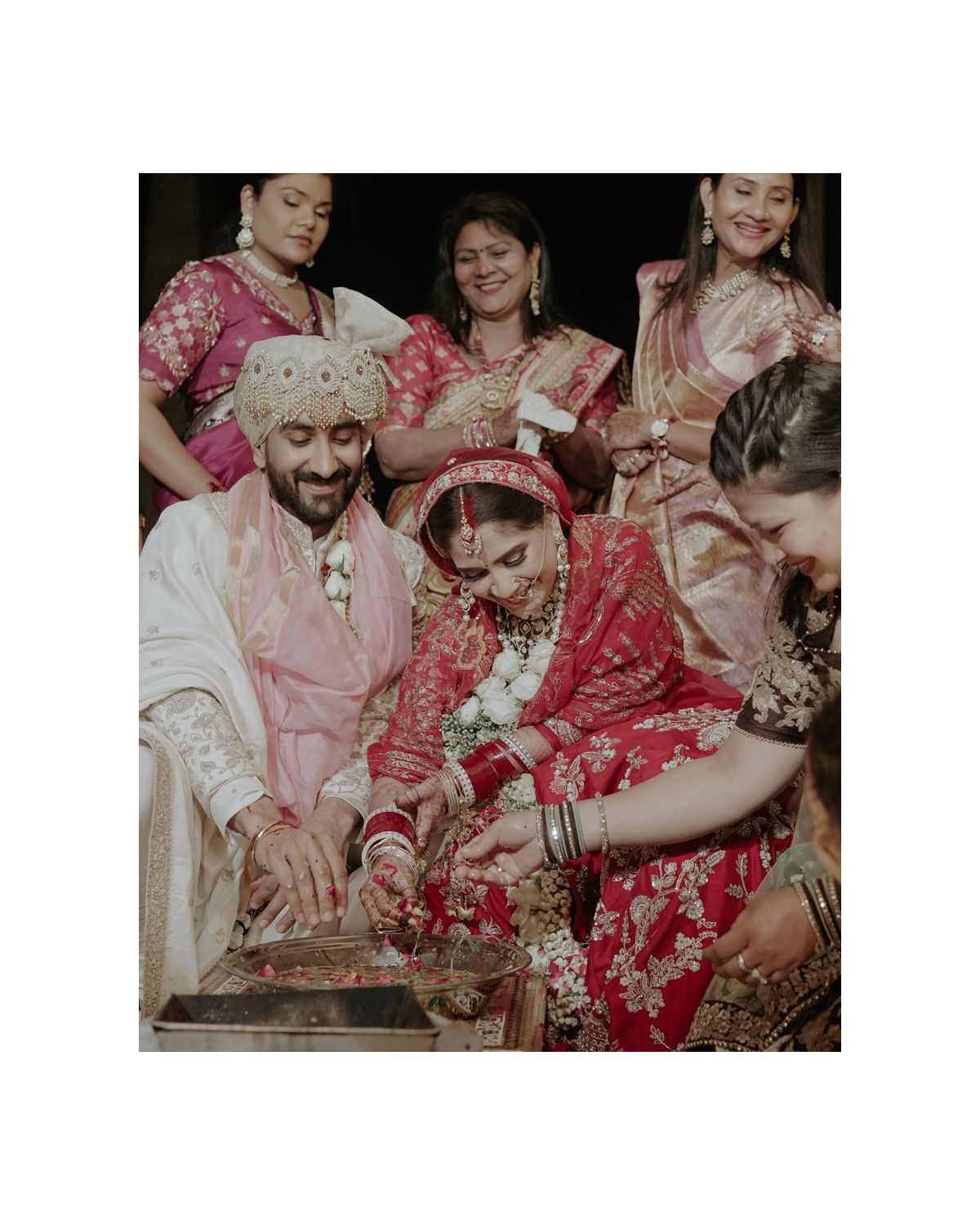 Wedding celebration showing traditional Indian ceremony rituals with family members.