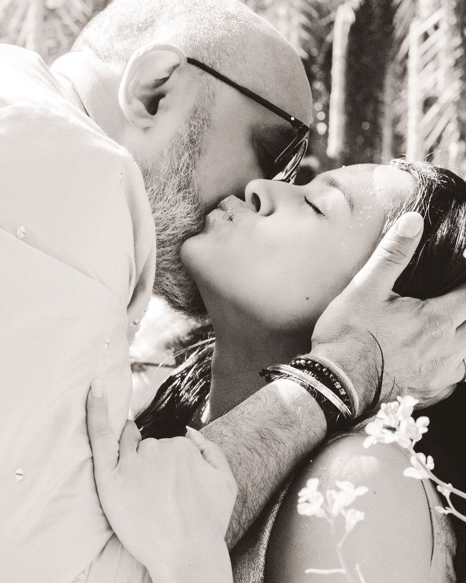 A series of romantic black and white photos showing intimate close-up moments between a couple.