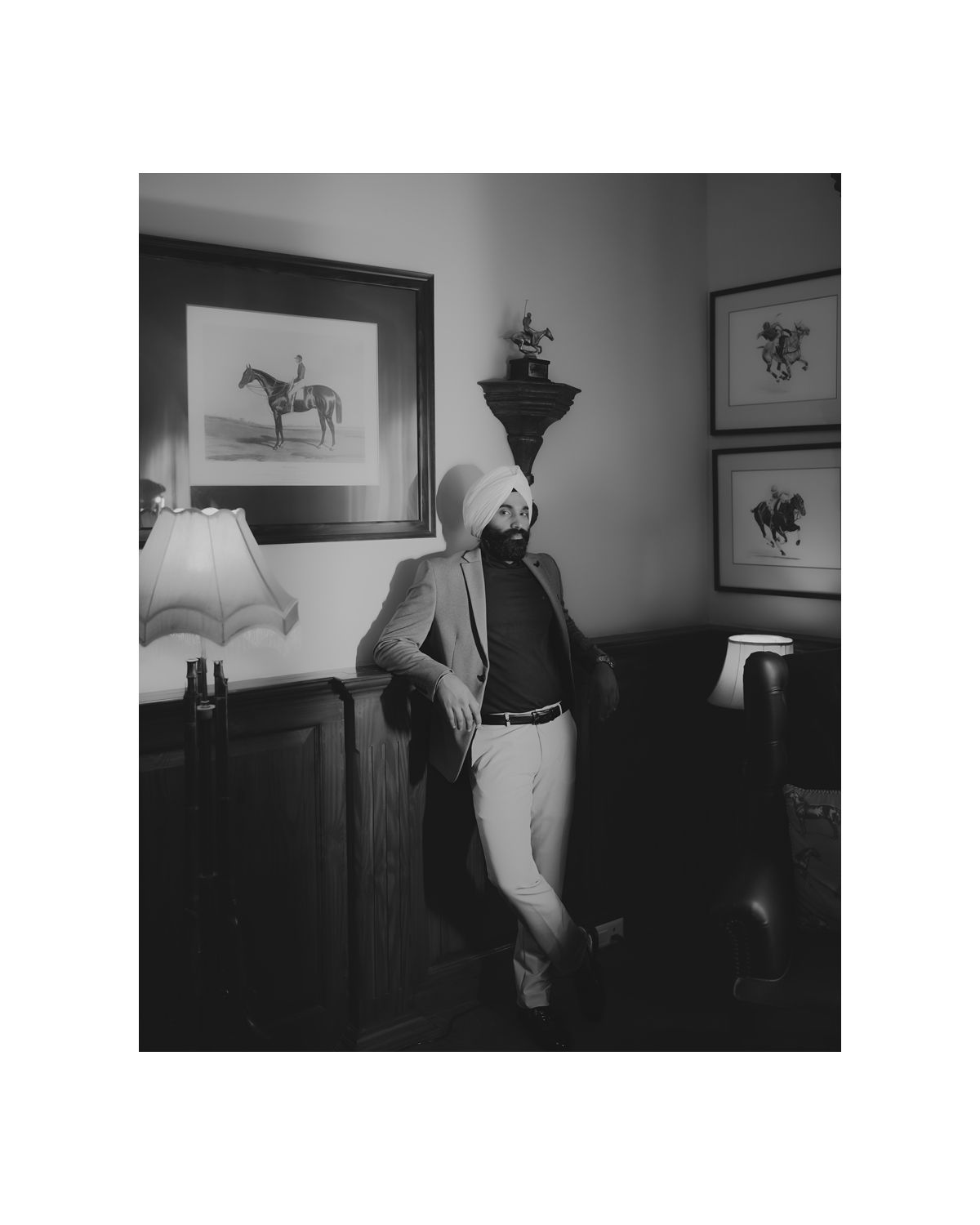Interior room with framed horse artwork and vintage decor.