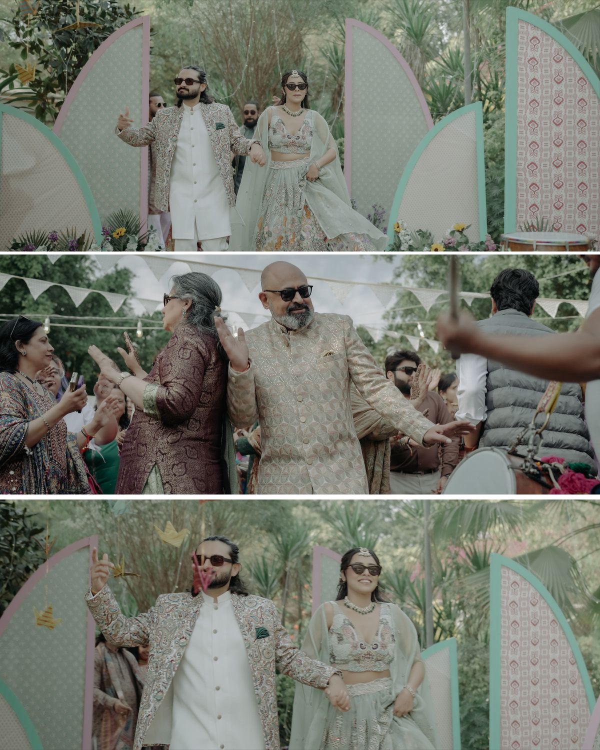 A festive Indian wedding celebration with guests dancing outdoors under decorative white scalloped decor and greenery.