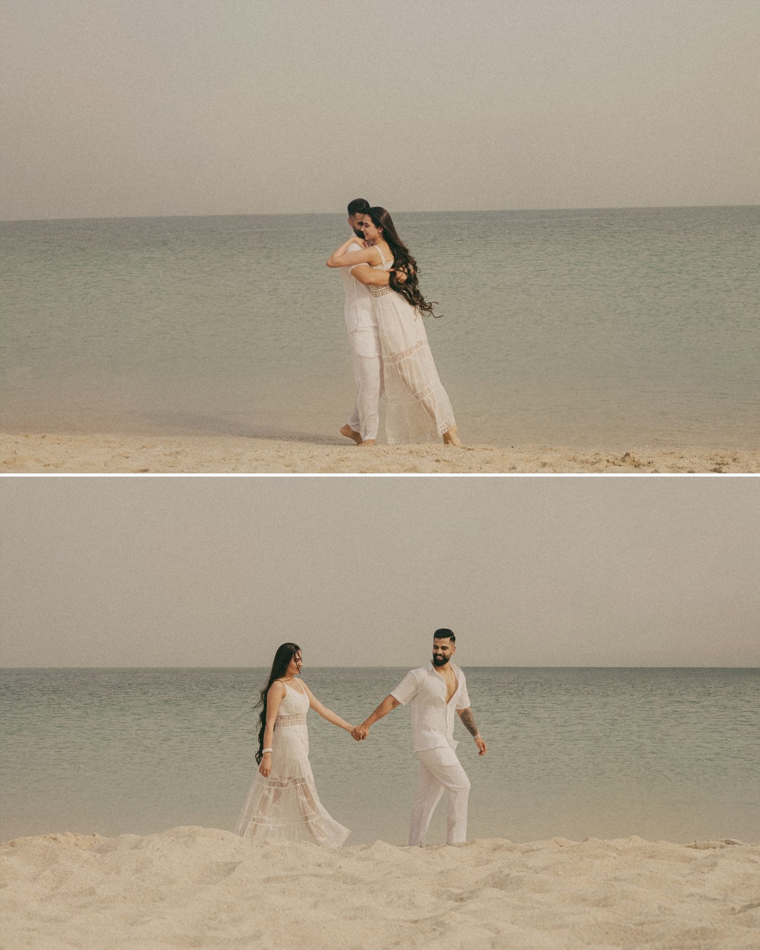 Couple in white outfits sharing a romantic embrace and holding hands on a sandy beach with calm turquoise waters.