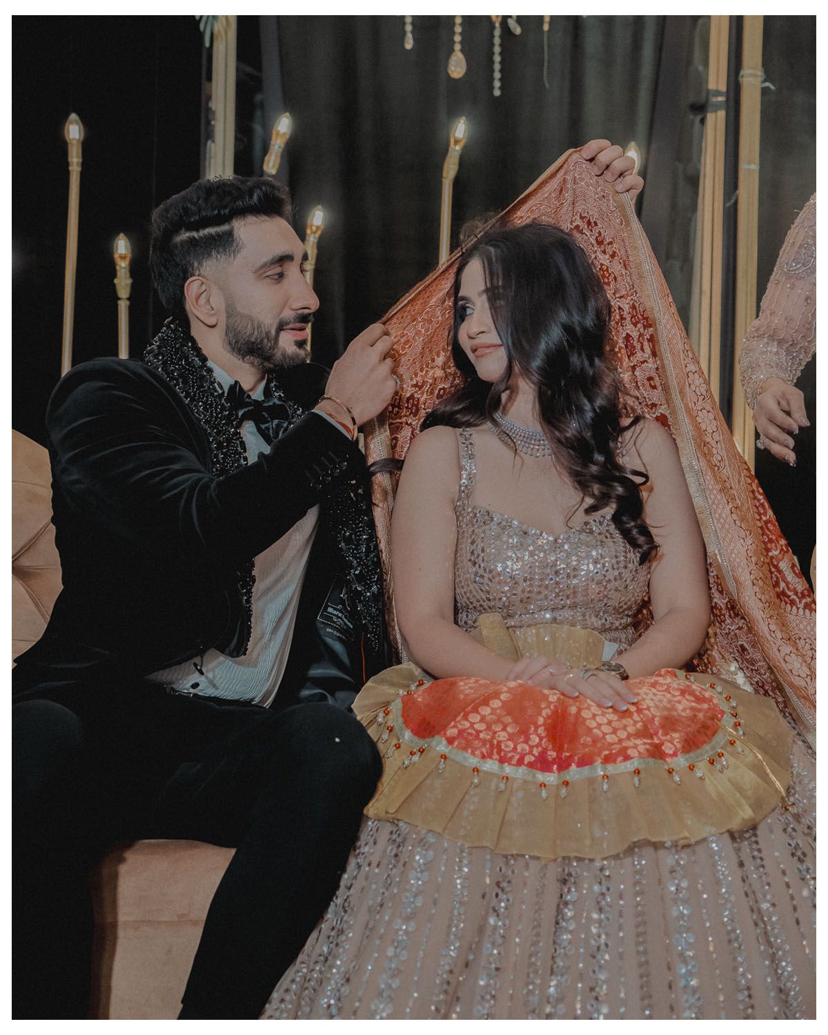 Celebration moment captured with sparkly gown and formal attire under ambient lighting.