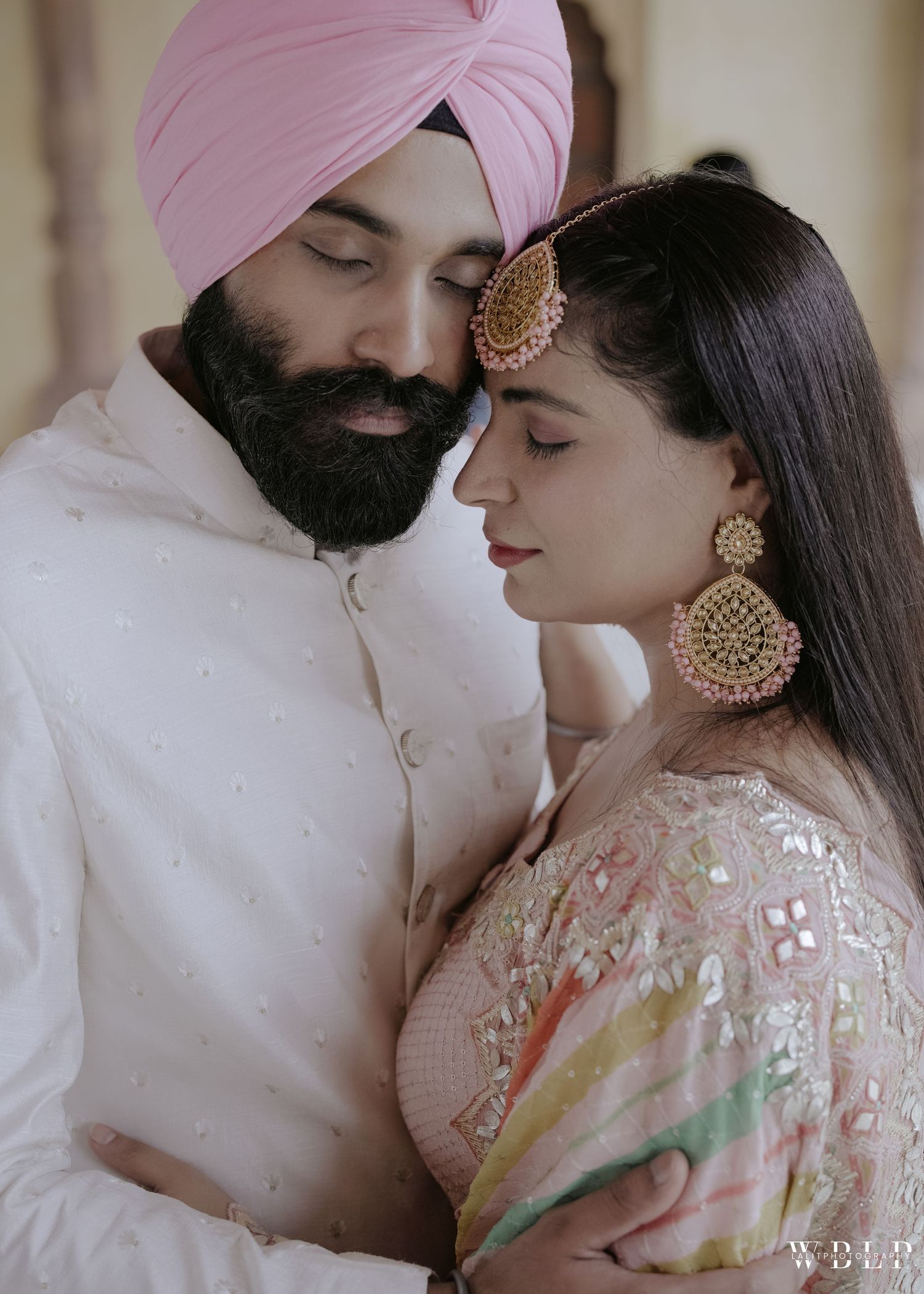 Intimate portrait showcasing traditional Sikh and Indian wedding attire with ornate jewelry.
