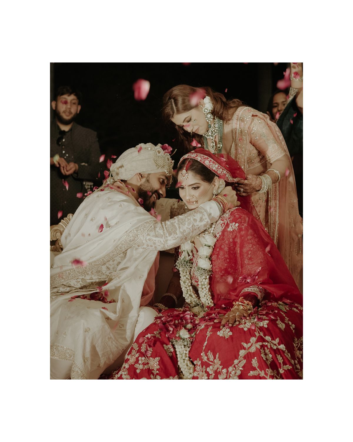 Intimate wedding ceremony moment captured during traditional Indian rituals.