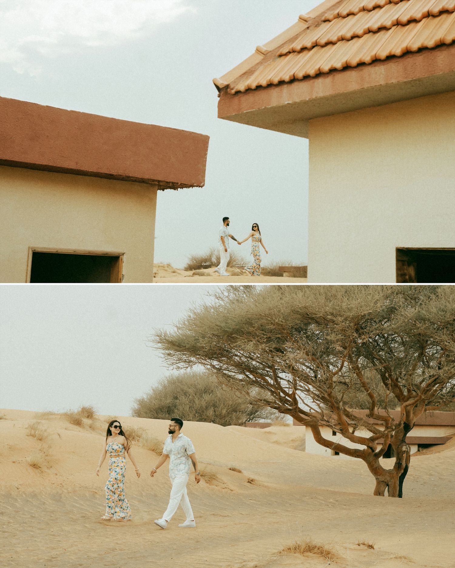 Couple holding hands between desert buildings and walking on sand dunes near an acacia tree in a arid landscape.