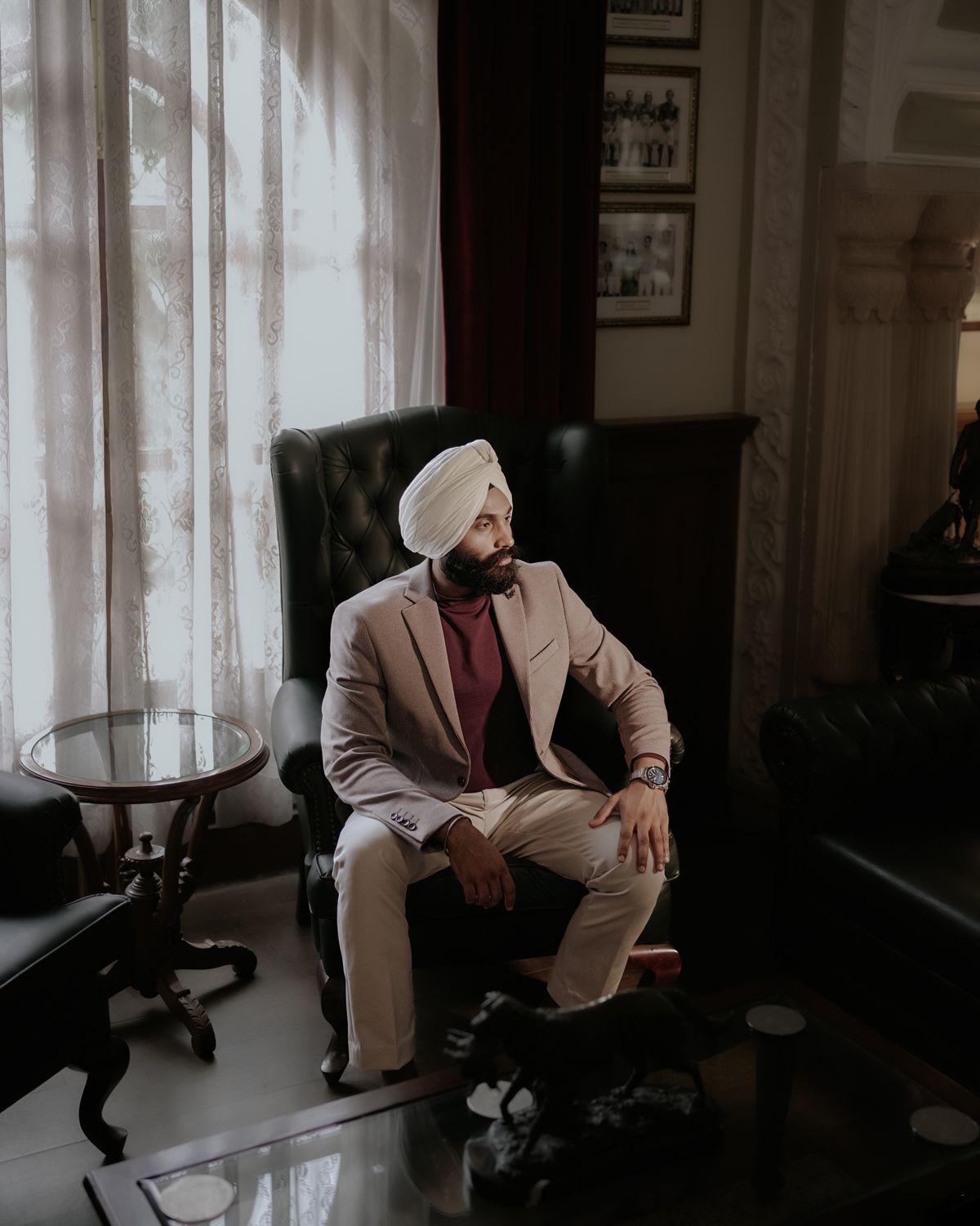Interior portrait in a luxurious sitting room with leather furniture and natural window light.