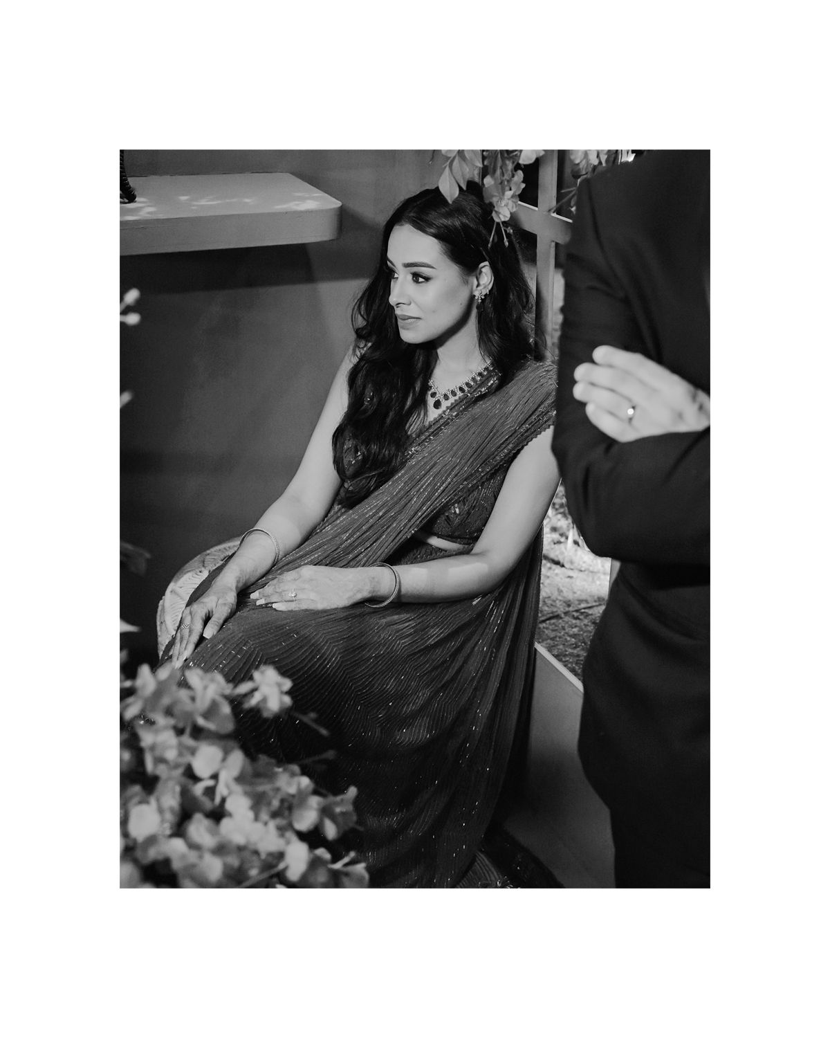 Black and white portrait of elegant saree and jewelry during preparation.