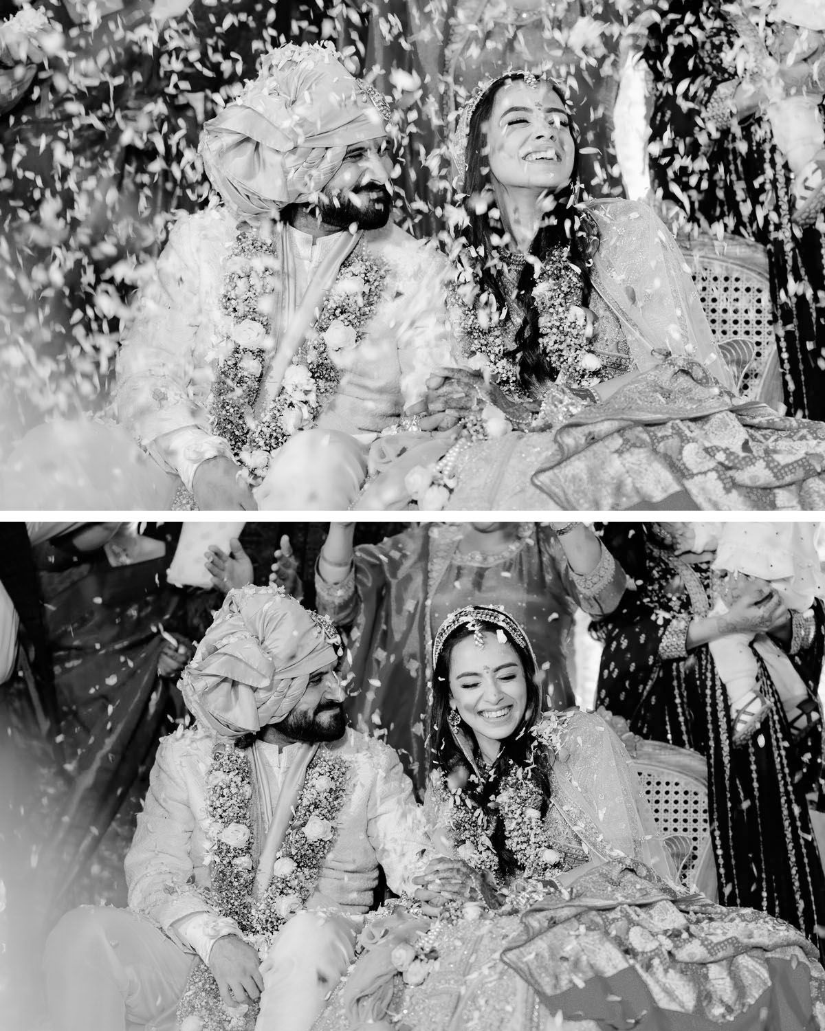 A black and white wedding photo capturing a joyful couple amid falling confetti during their traditional Indian ceremony.