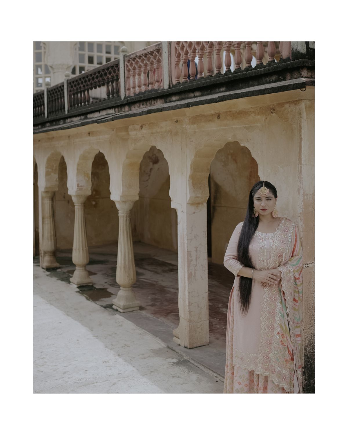 Traditional Indian architecture with arched colonnade and decorative details in classical style.
