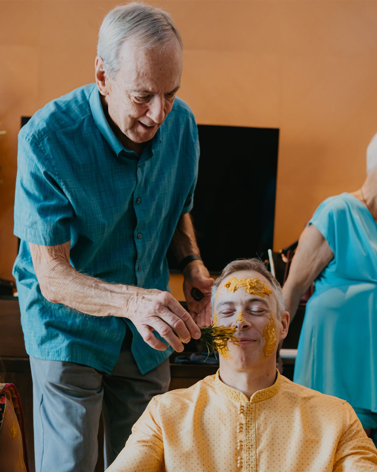 Traditional Haldi ceremony preparation with yellow turmeric application.
