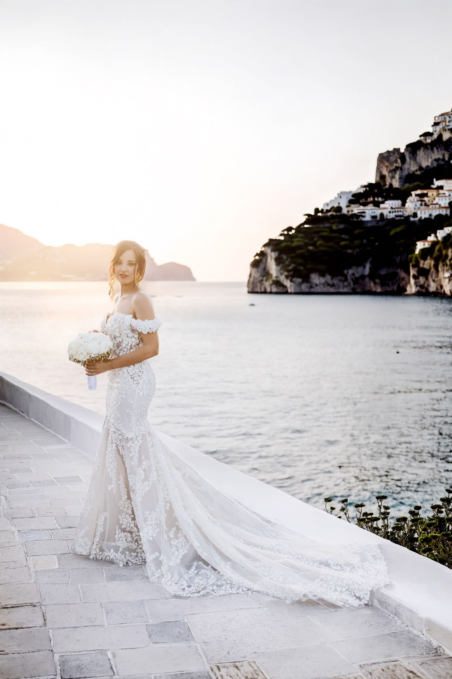 Bride surrounded by soft Italian light during an intimate wedding morning.