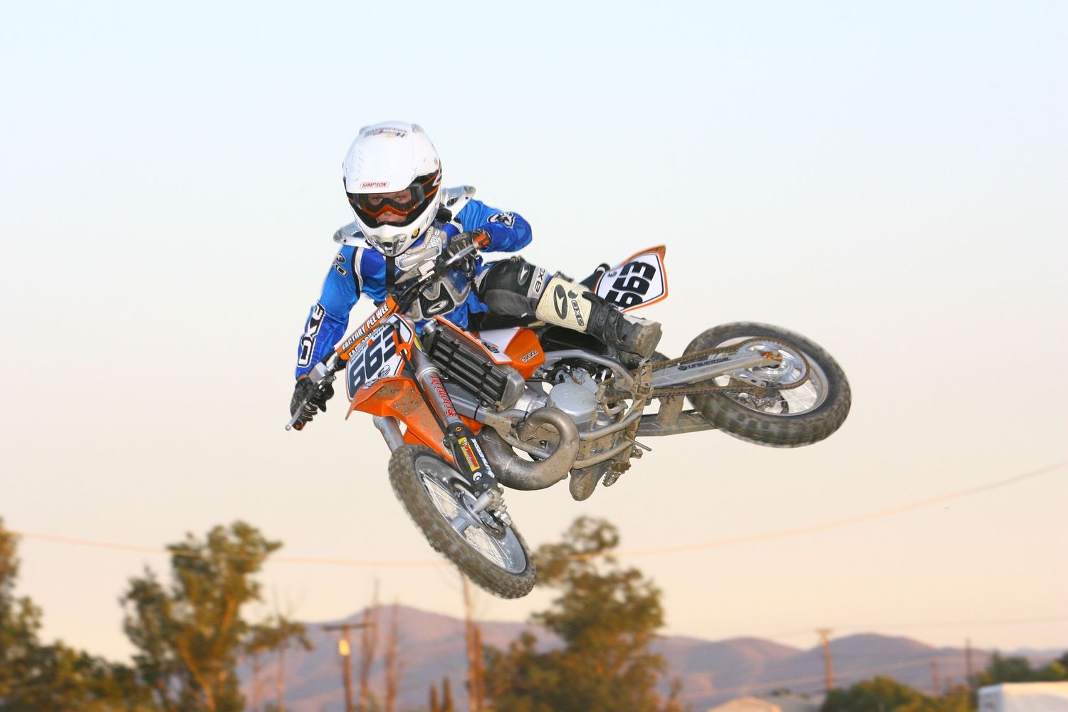 Young motocross rider doing a whip at Perris raceway as photographed by SirSmileyMX