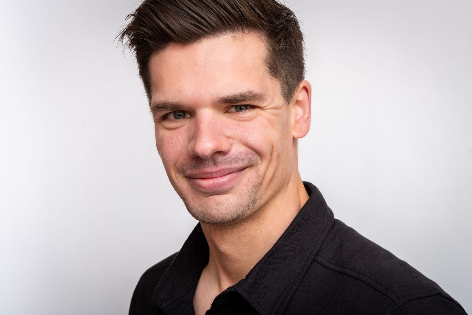 Professional headshot series showing the same person in four different poses against a light background.