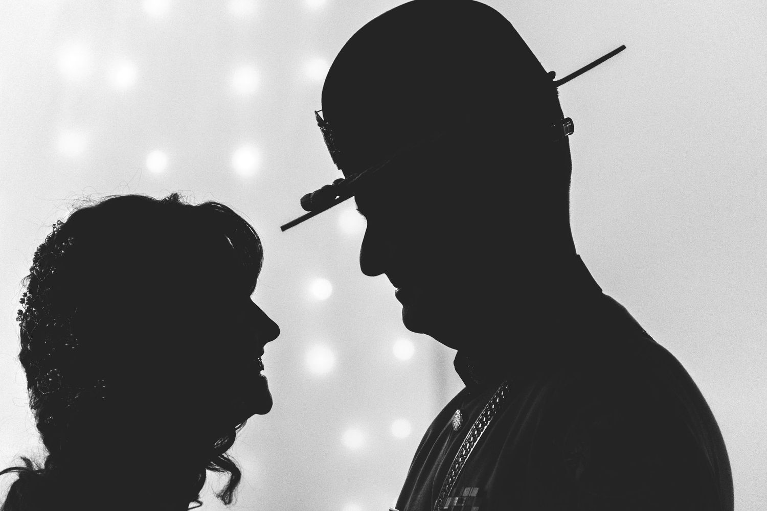 Silhouettes of people lined up against a light background creating dramatic profiles. Whitney McLaren Photography