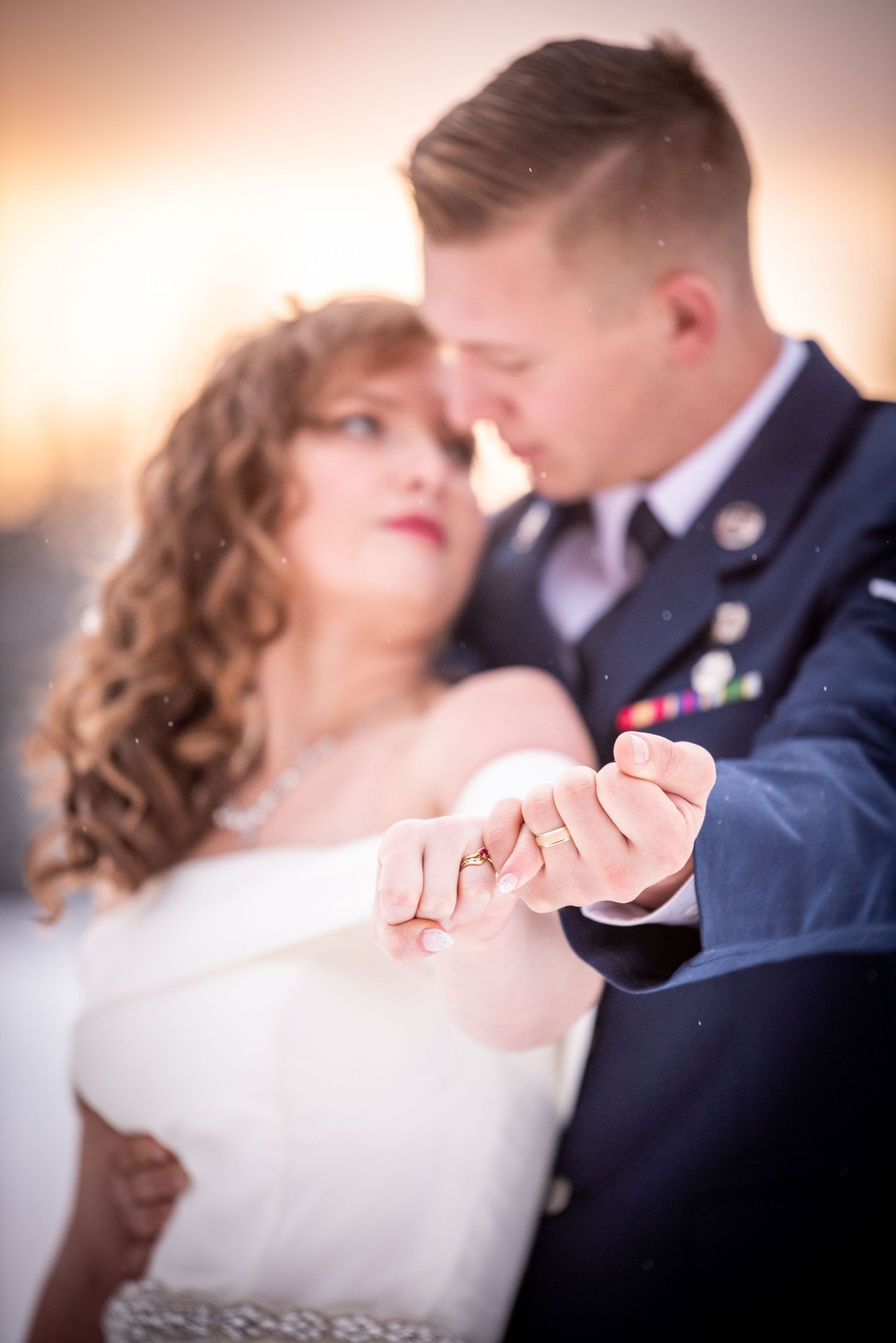 Romantic dance pose between couple in formal attire with warm lighting. Whitney McLaren Photography