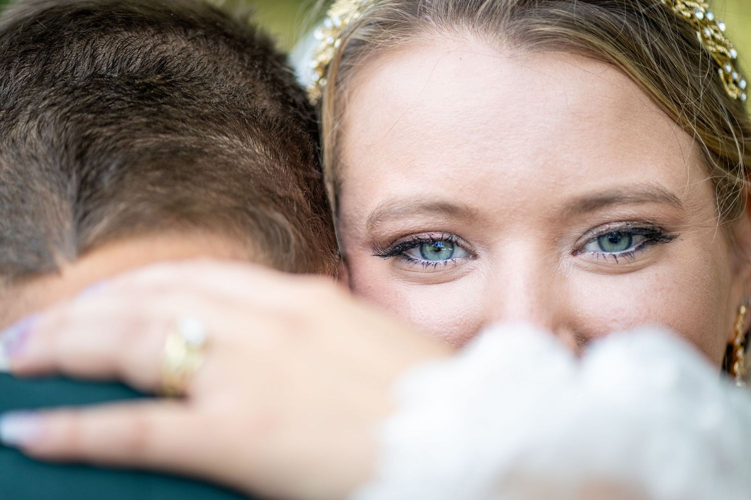 Artistic close-up wedding photography focusing on eyes and veil details. Whitney McLaren Photography