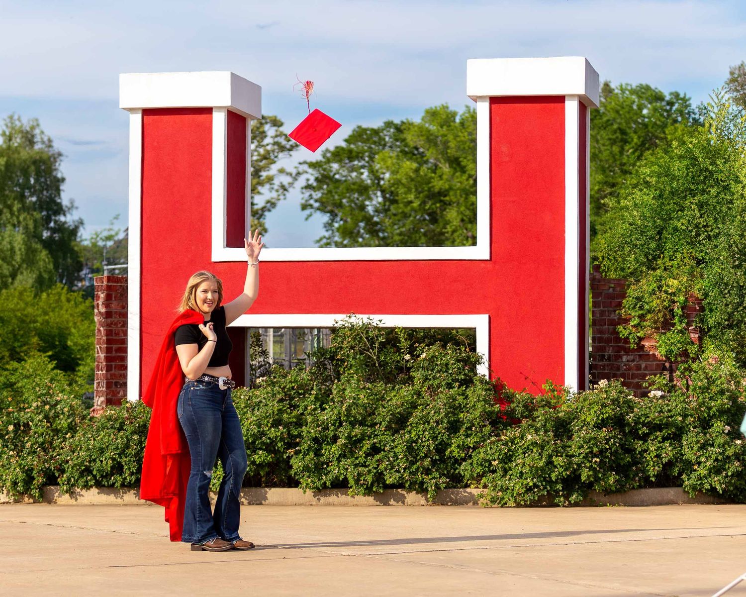 A bright red and white building facade with modern architectural elements against a blue sky at Haughton High School in Louisiana .