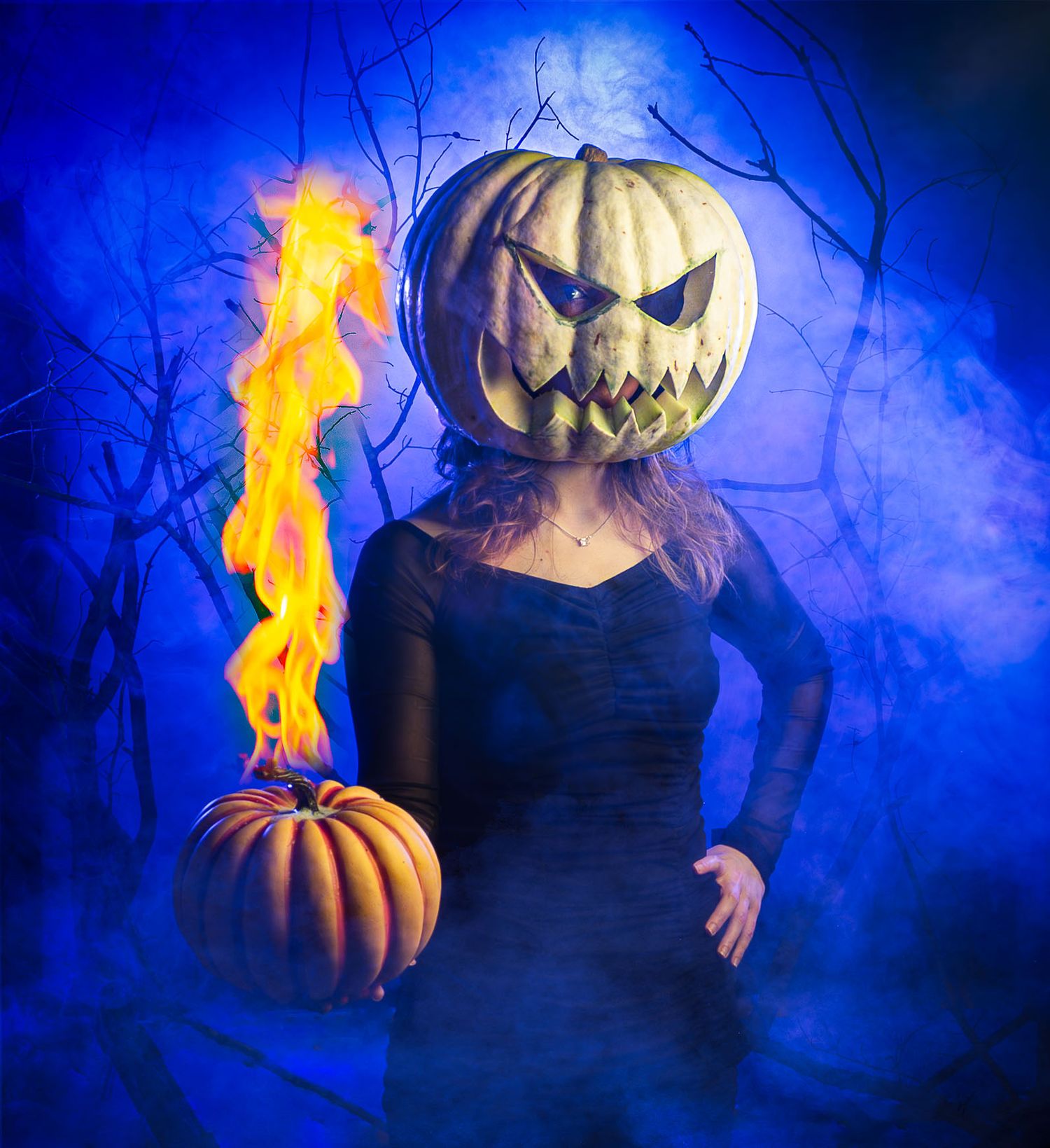 A spooky Halloween scene with a jack-o-lantern pumpkin head figure holding a flaming pumpkin against a dark blue background.