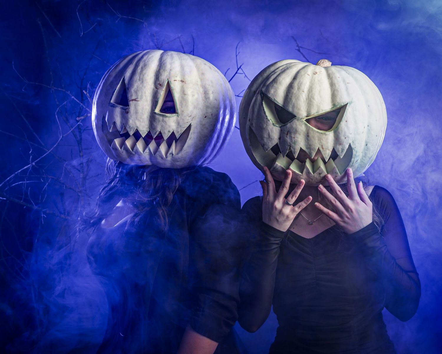 A sequence of spooky Halloween pumpkins with glowing faces emerging through blue fog and dramatic lighting.