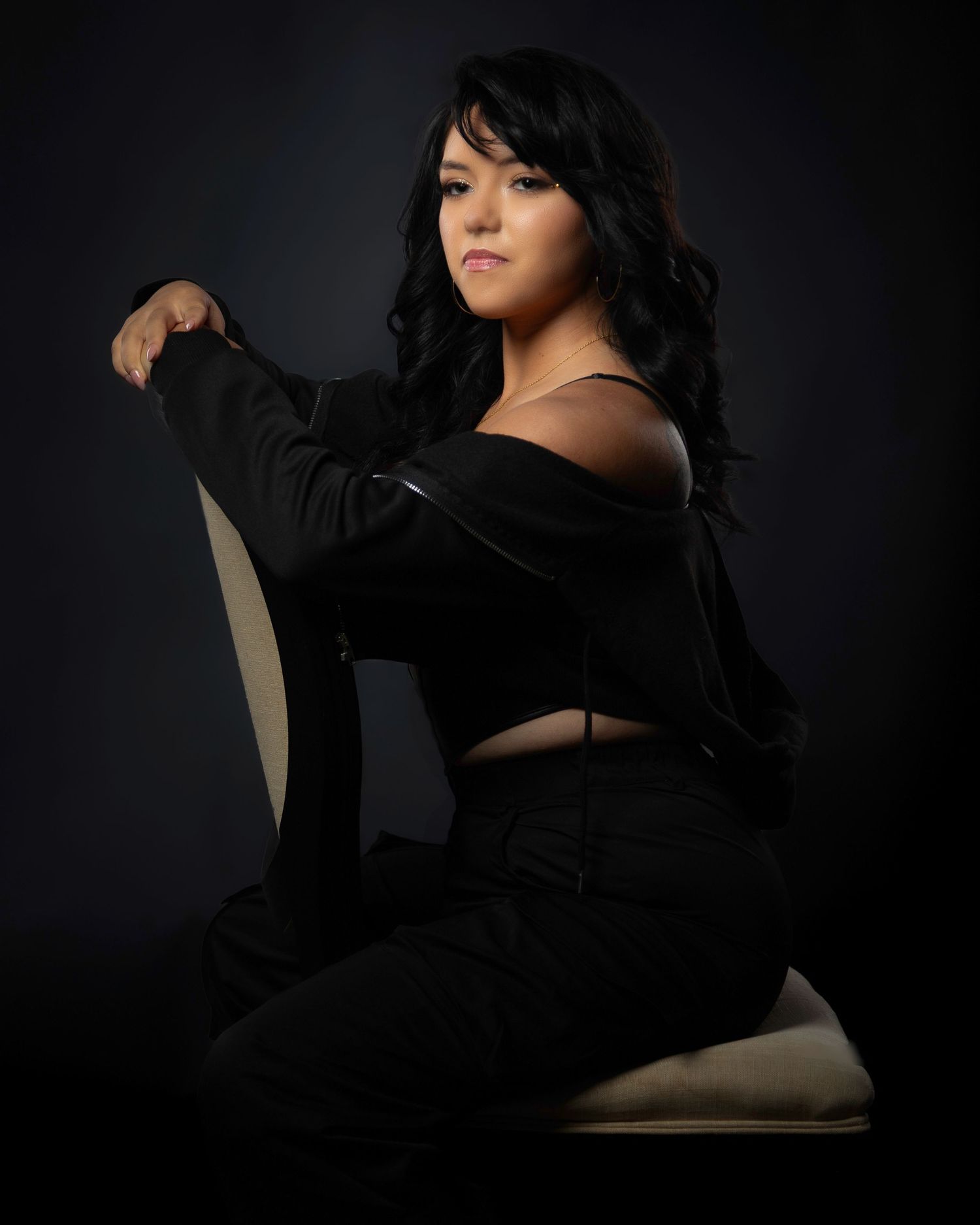 Dramatic portrait series in dark lighting with figure in black clothing posing against shadowy background.