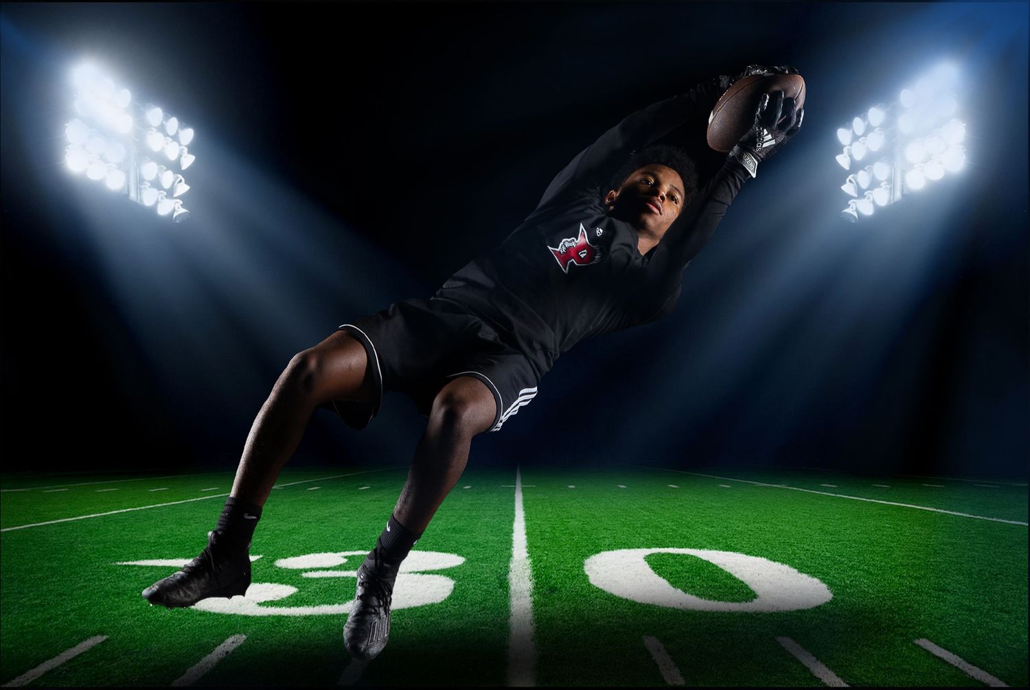 Dramatic sequence of a football player making a diving catch on a green field at night.