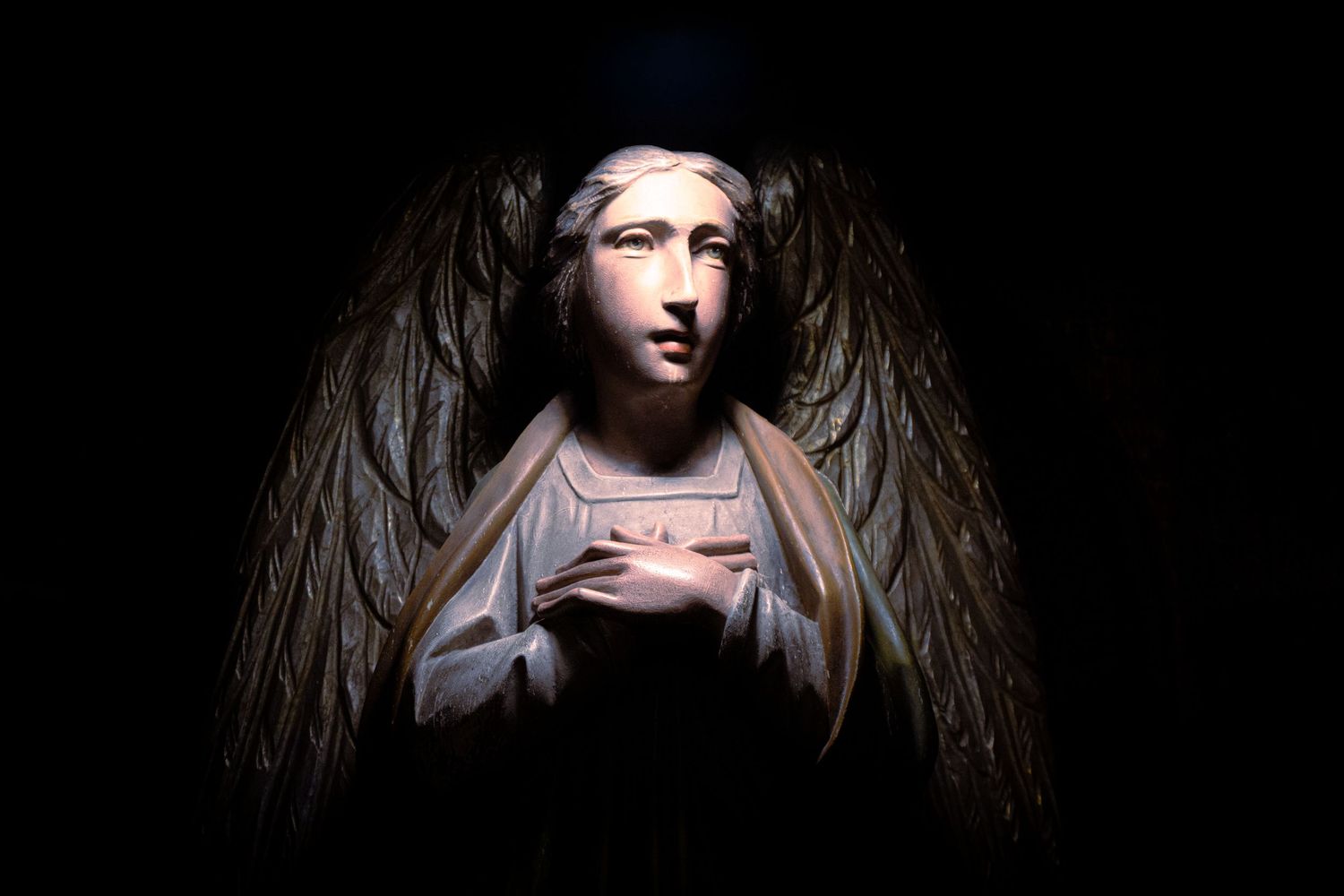 A dramatic sequence of dark artistic portraits showing a figure emerging from shadows with dramatic lighting effects.