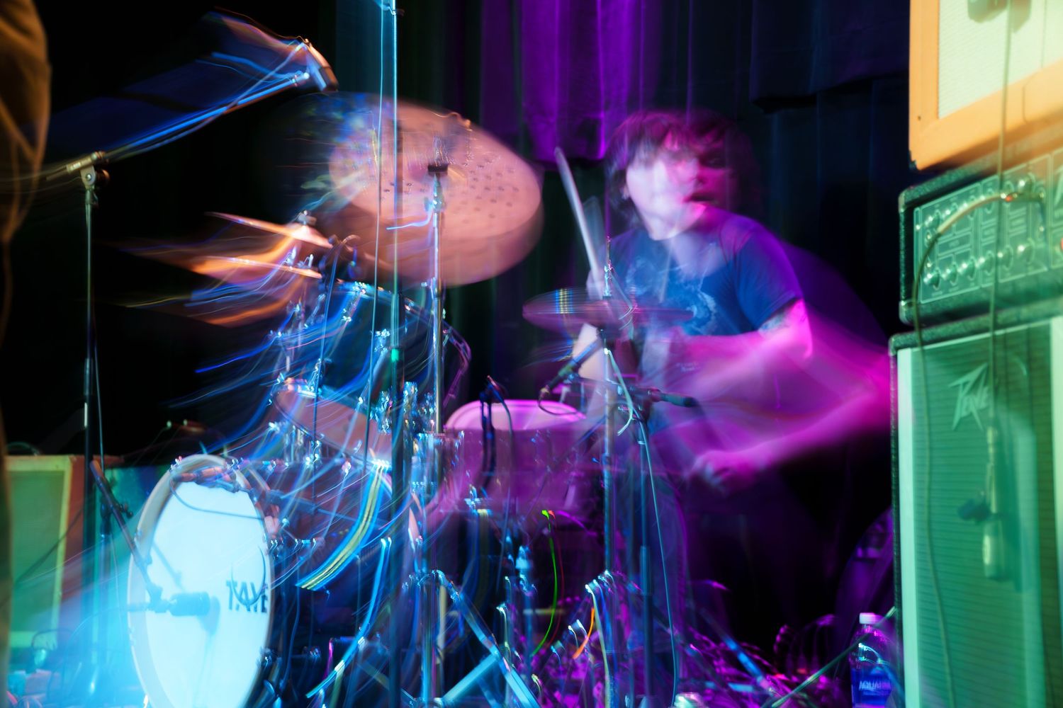 Colorful smoke and lighting effects create a dramatic atmosphere in a nightclub or entertainment venue.