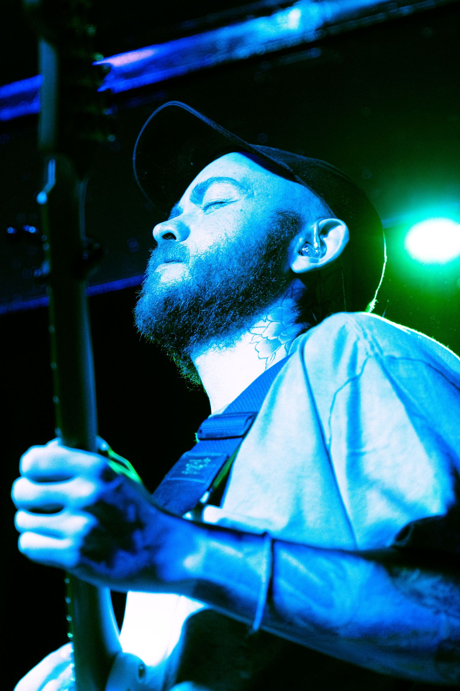 Dramatic blue-lit performance sequence showing a musician in dynamic poses under theatrical stage lighting.