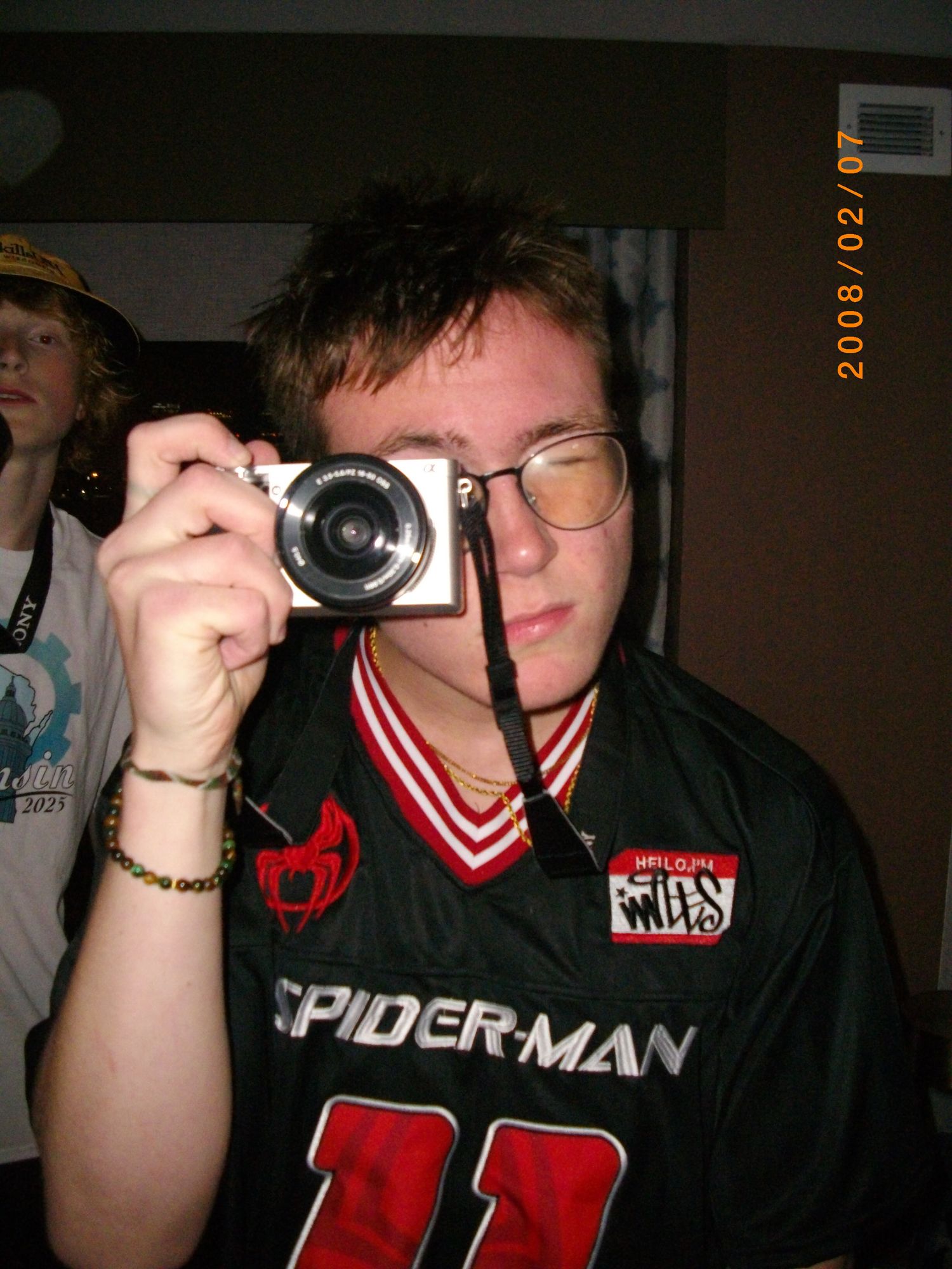 Dark indoor photos of people holding cameras with retro date stamp overlay.
