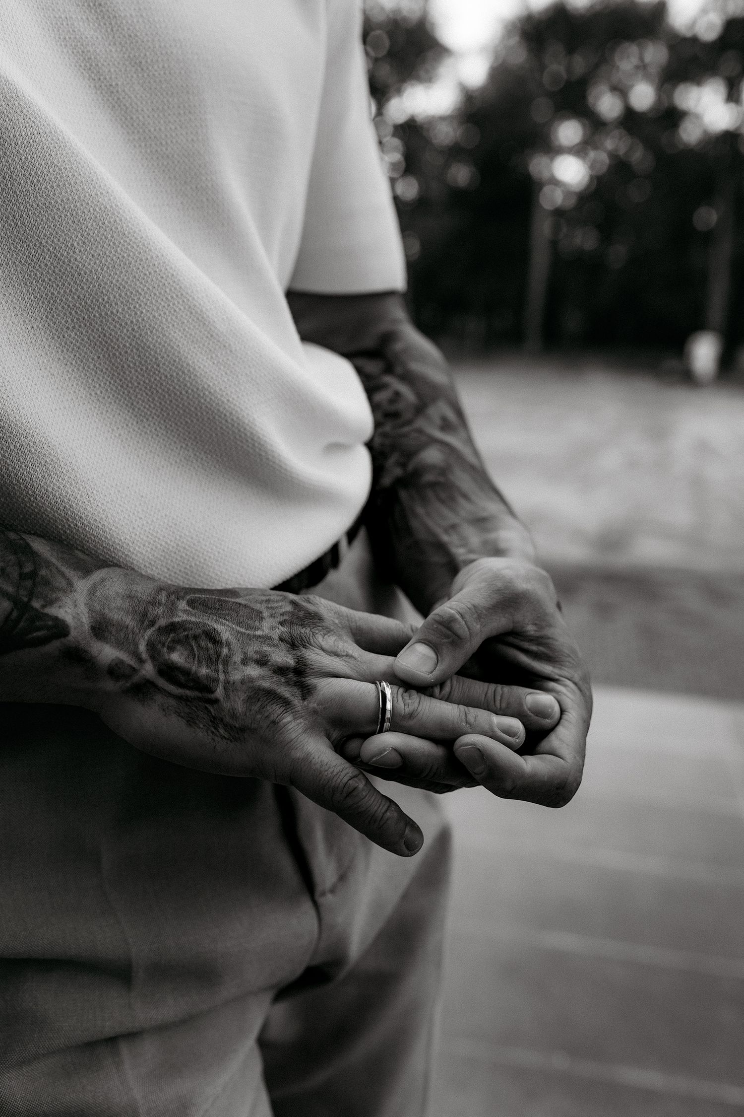 A series of black and white photos showing hands with a wedding ring in different close-up poses.