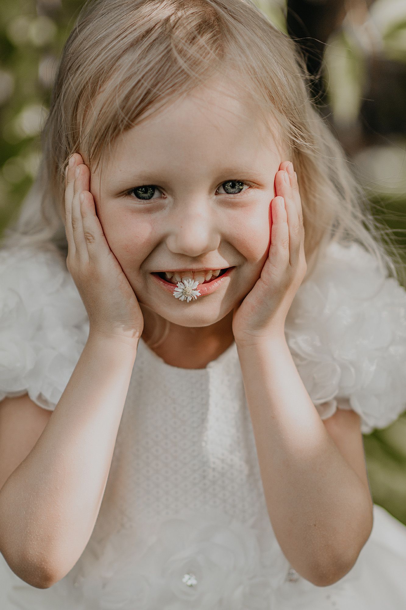 A sequence of playful expressions shows a child in white dress holding their cheeks and making silly faces.