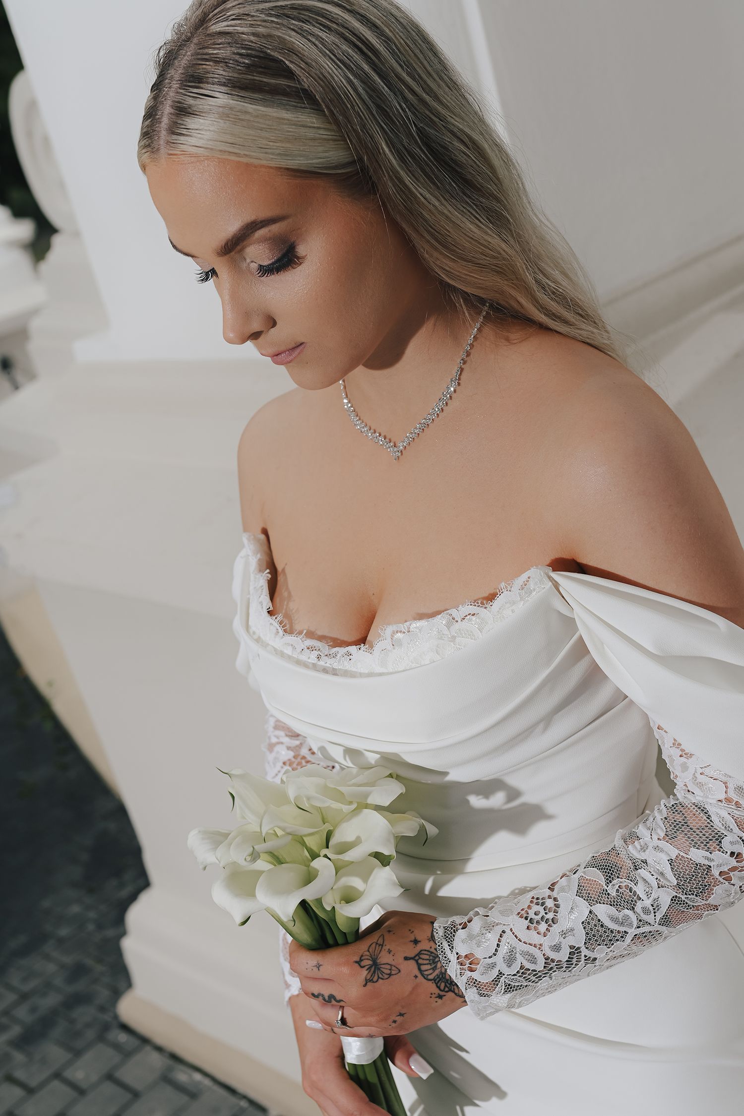 A series of wedding dress detail shots showing delicate lace sleeves and a white bouquet against a light background.