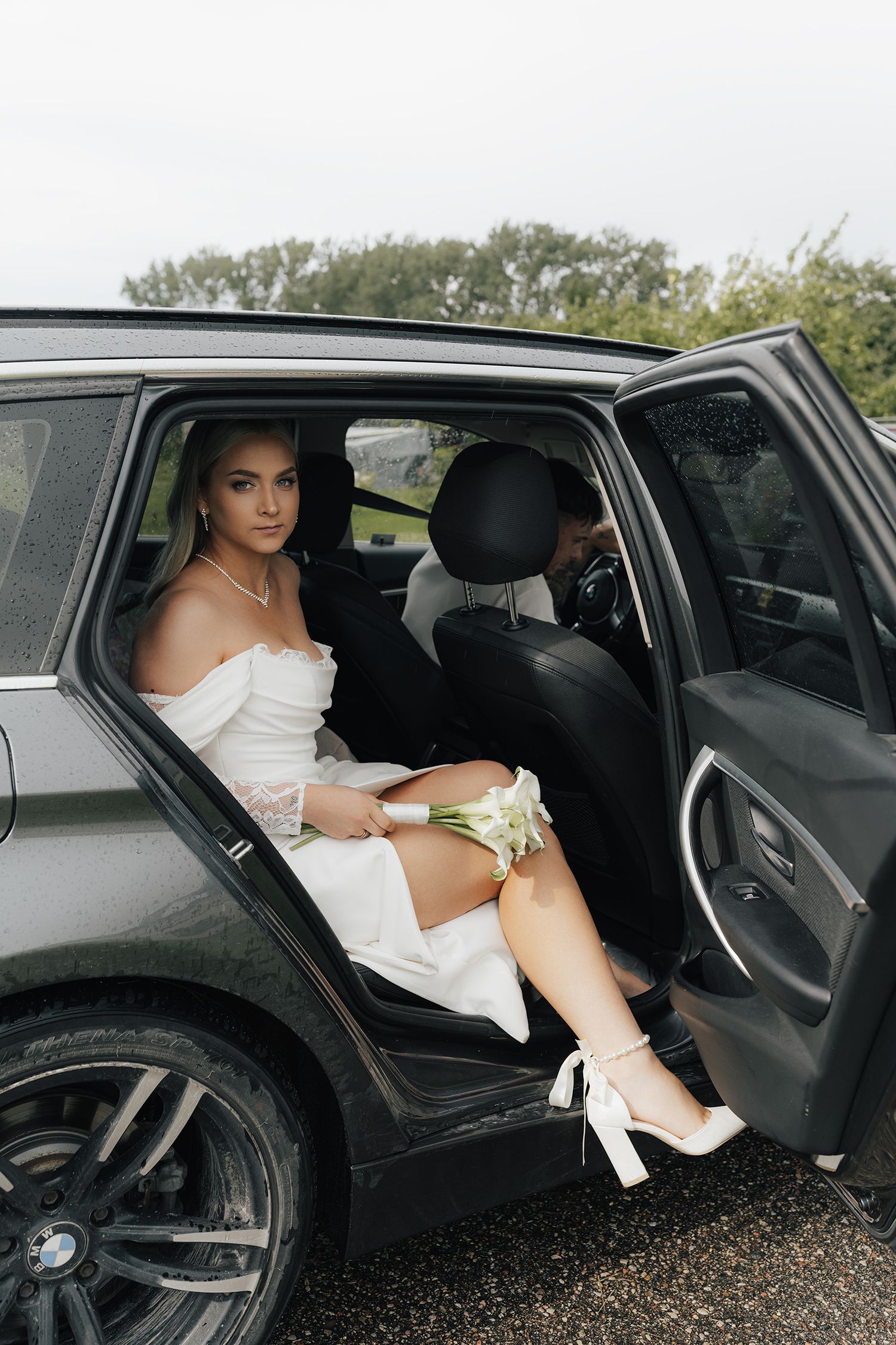 A bride in a white wedding dress enters the back seat of a luxury car in a series of sequential photos.