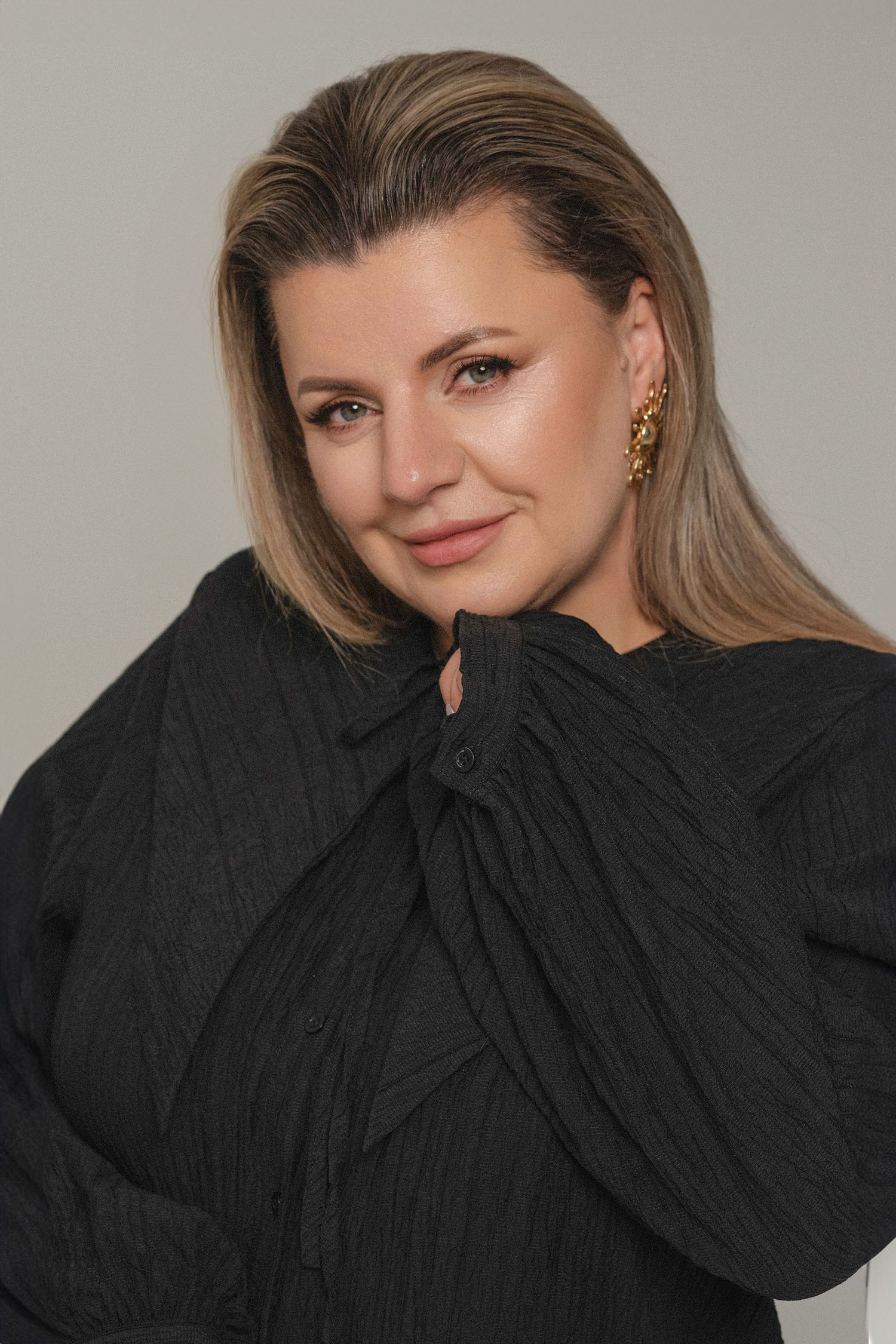 A series of fashion portraits showing a person in a black turtleneck sweater posing against a neutral background.