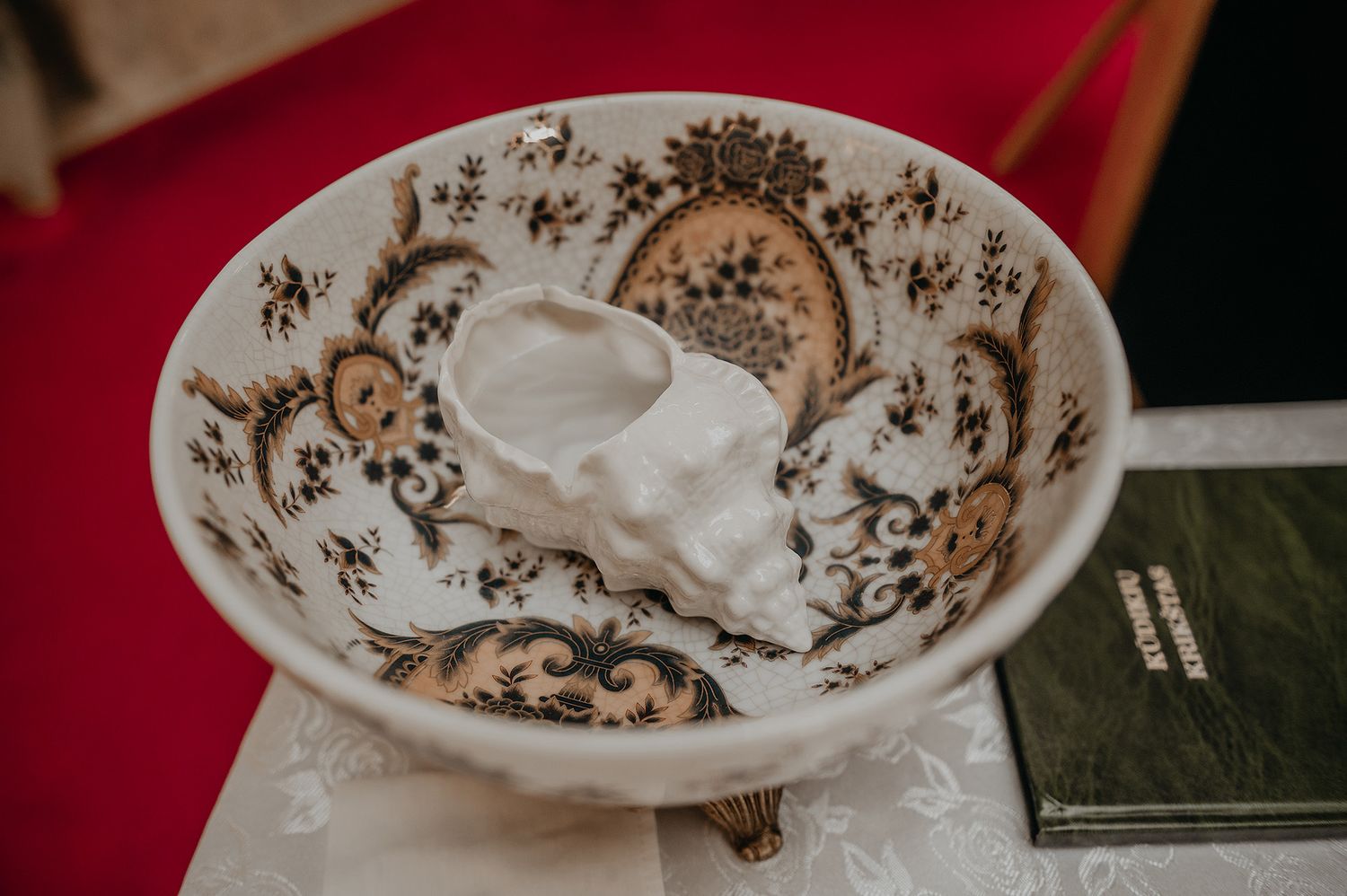 A collection of ornate brown and white vintage china plates with floral patterns displayed in a row.