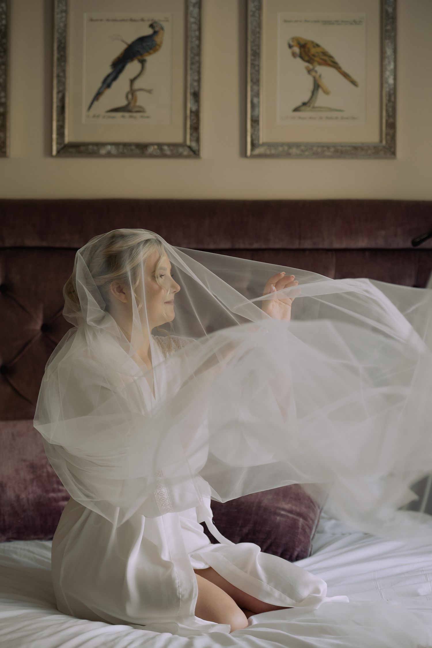 A series of photos showing a figure draped in flowing white tulle fabric creating an ethereal boudoir scene.