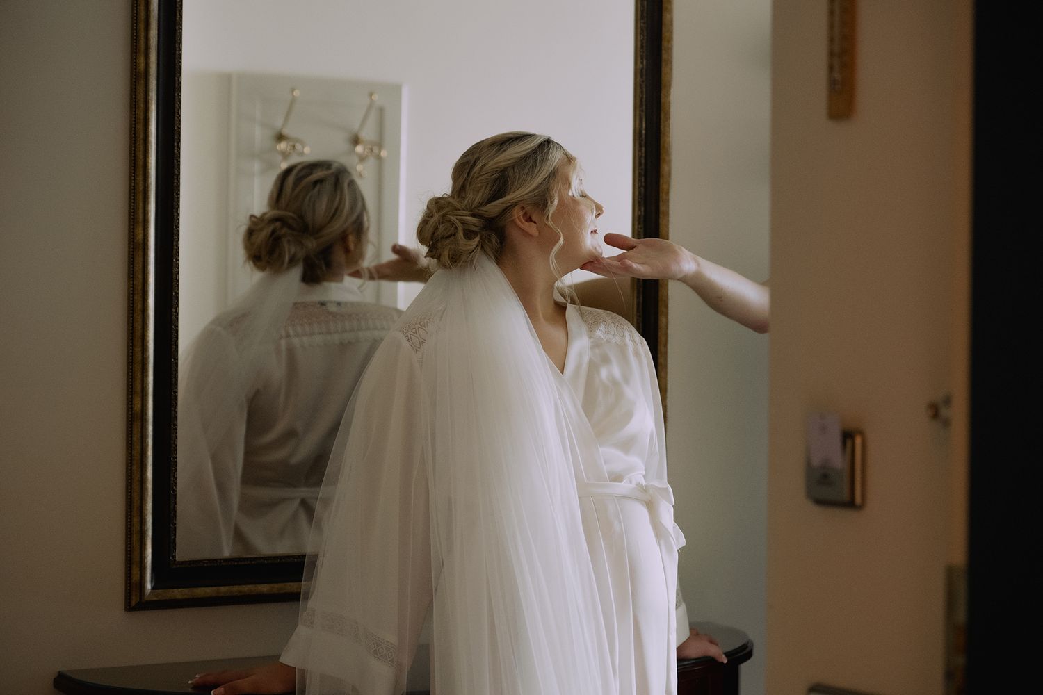 A bride in a white wedding dress and veil is shown in a collage of getting ready moments on her wedding day.