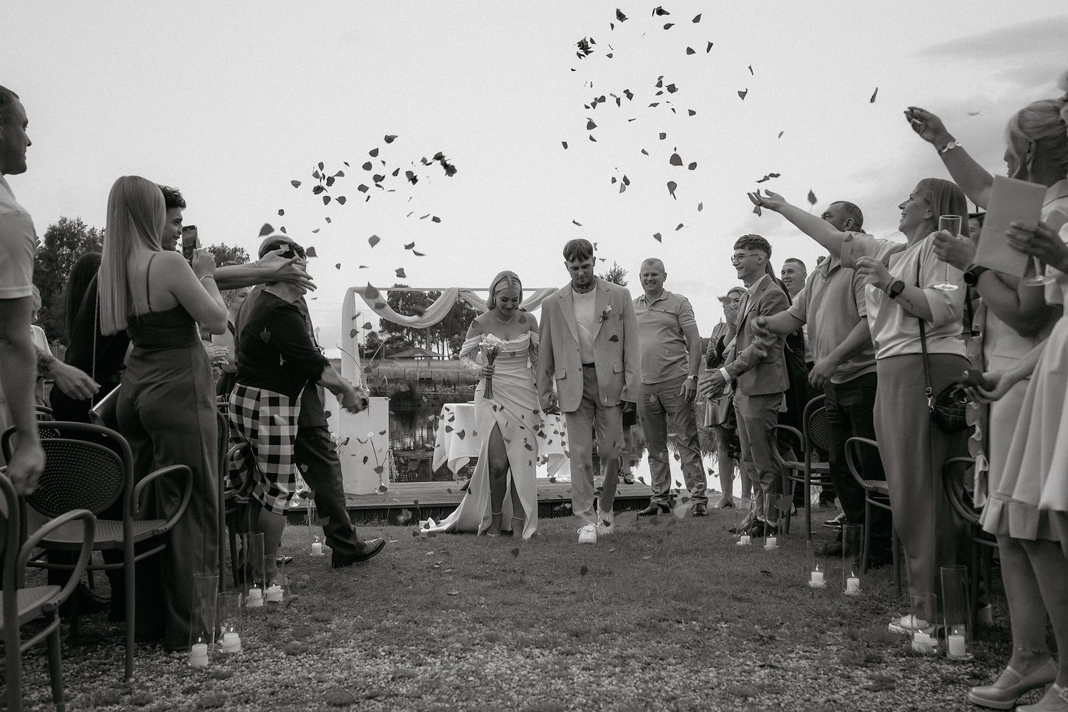 Black and white panoramic photo shows a crowd gathered outdoors at a community event in a rural setting.