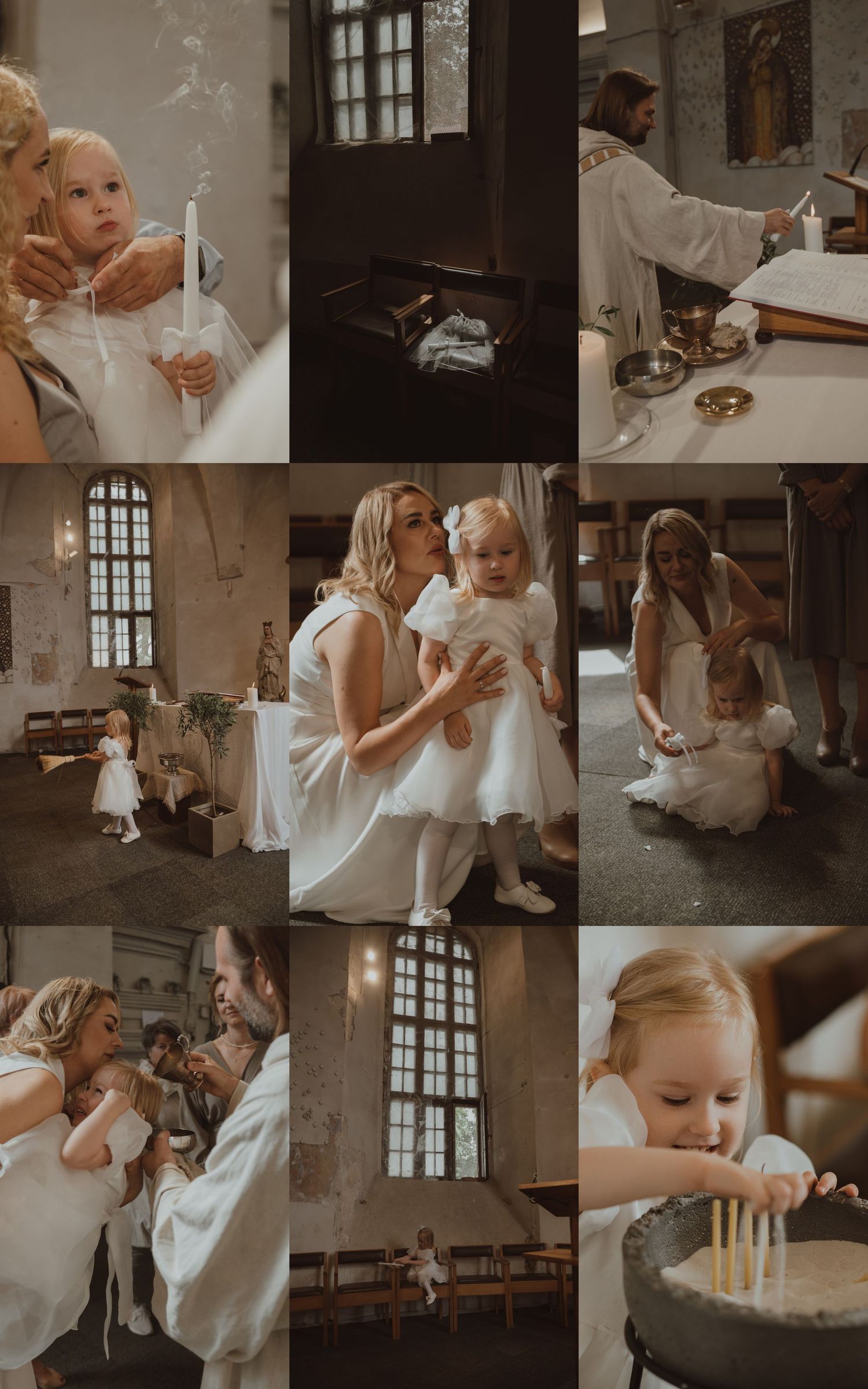 A young girl in white dress holds a candle during a baptism ceremony in a rustic church with a priest and family.