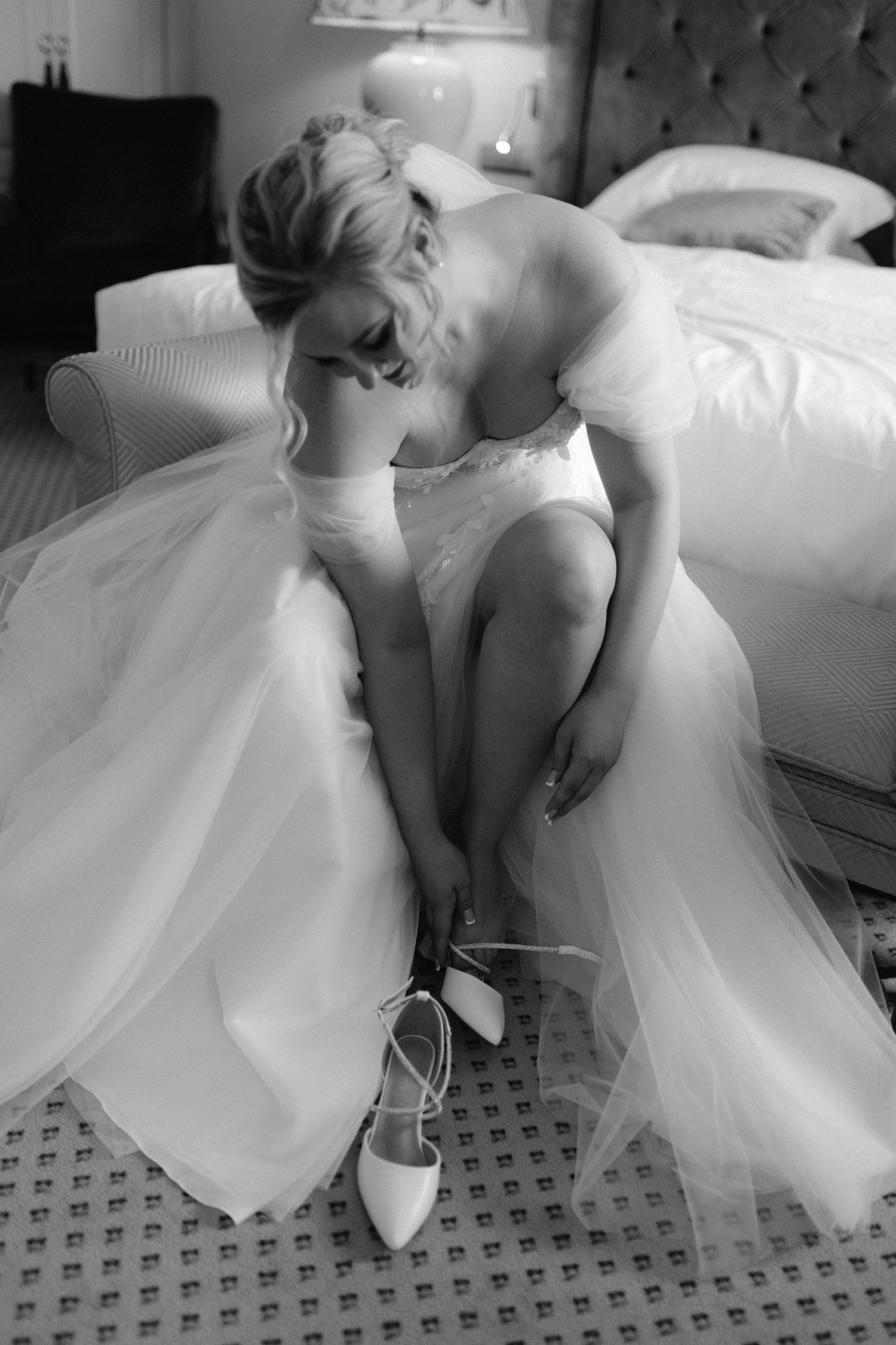 A series of black and white photos showing a ballet dancer in a white tutu dress bending gracefully in different poses.