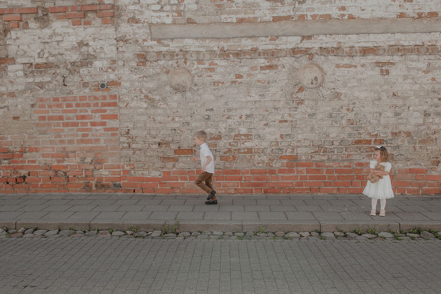A brick wall background with white paint peeling off reveals weathered red bricks underneath.