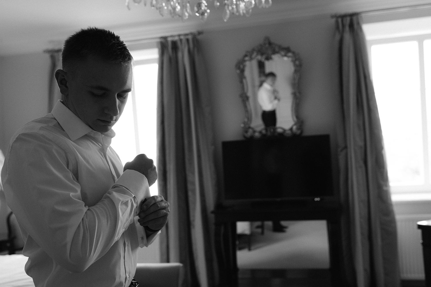 Four sequential photos show someone in a white shirt adjusting a necktie in front of a window.