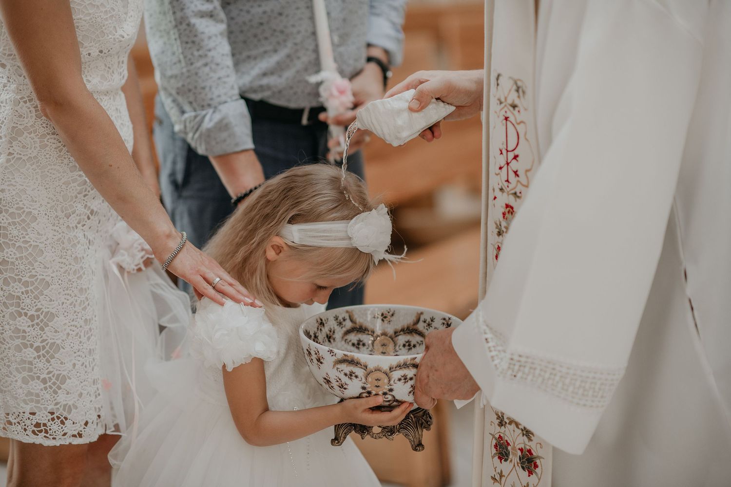 Close-up details of a bride getting ready with white lace dress and delicate accessories.