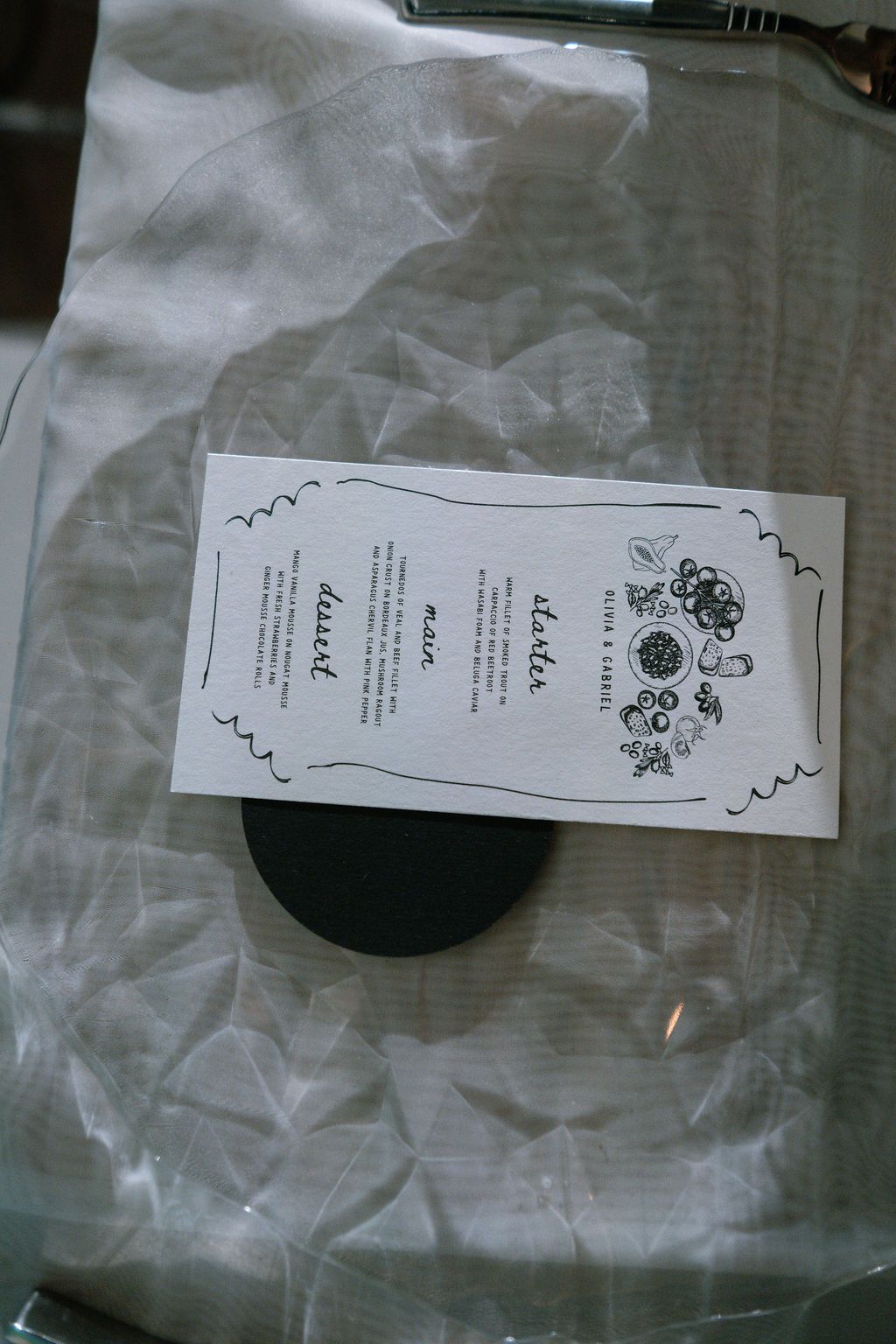 Black and white restaurant menu card on a transparent plastic chair seat.