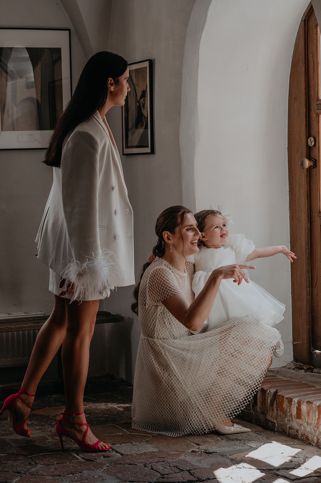 A series of artistic photos showing a bride in a white dress and red shoes sitting and posing in different positions.