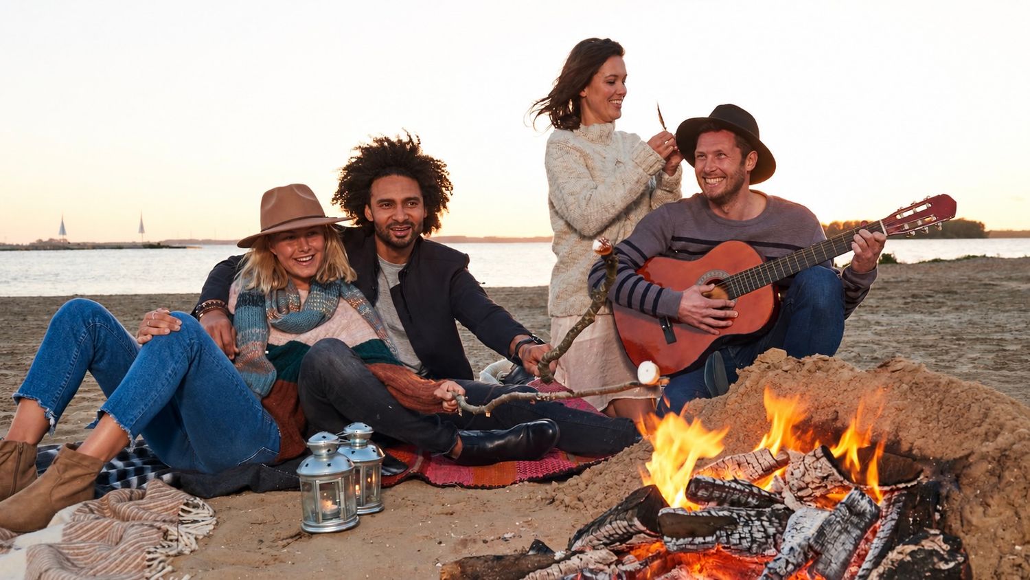 Peter Schotting commercial lifestyle model enjoying a beach campfire at sunset