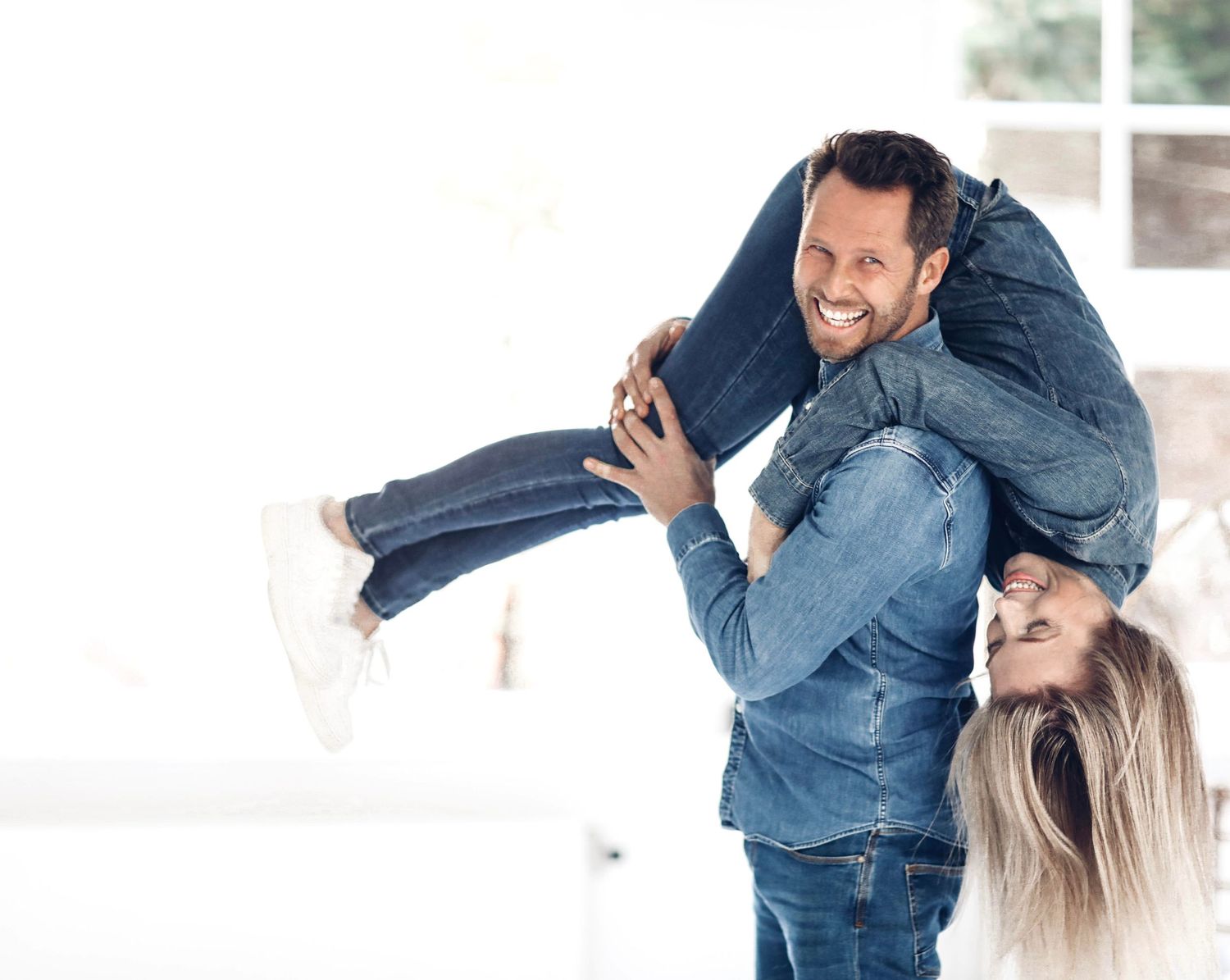 Commercial lifestyle couple, playful interaction, natural light, modern relationship, advertising campaign, European models