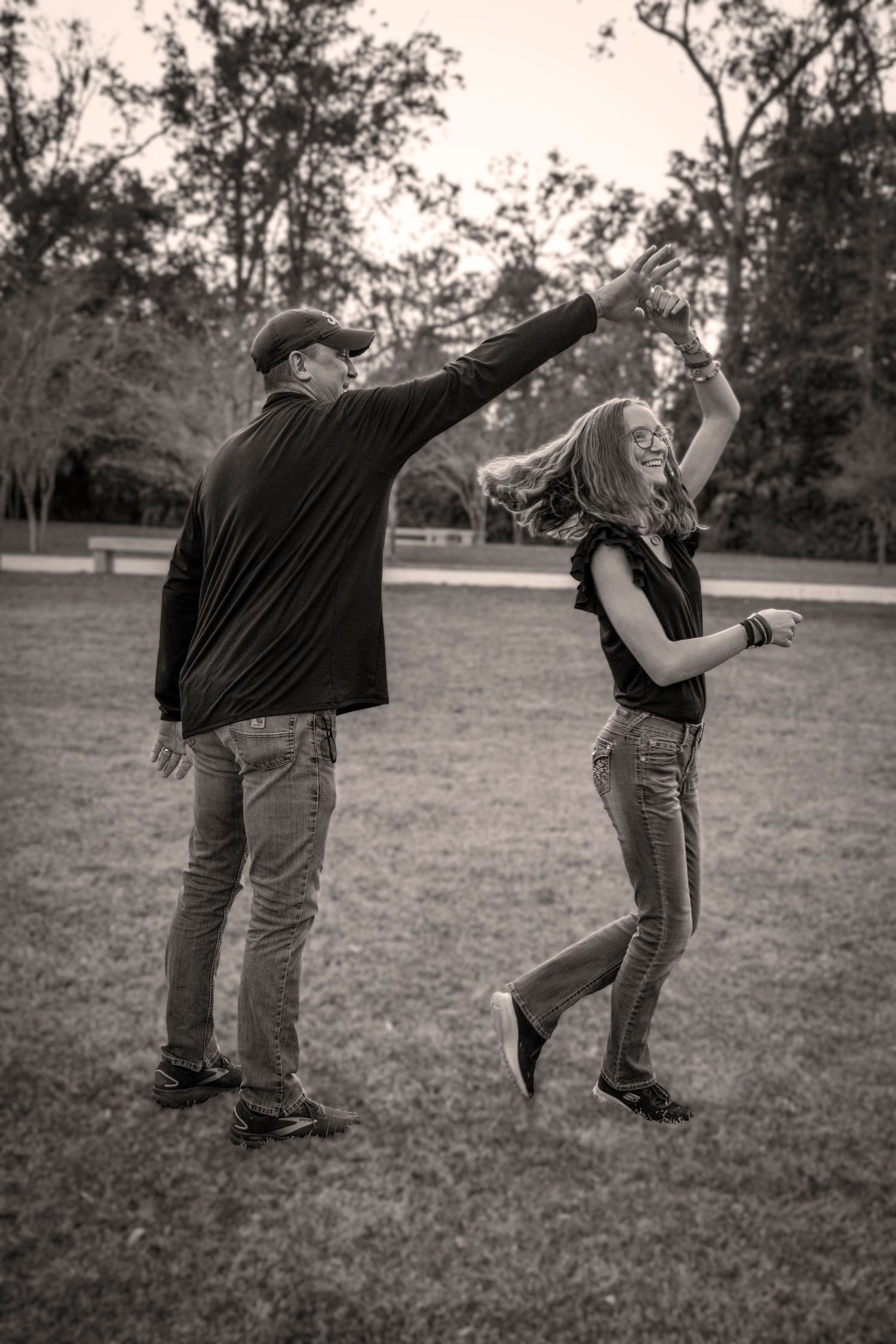 Portrait photographer Hinesville GA, playful dance field sunset black white session — The Quiet Lens Studio