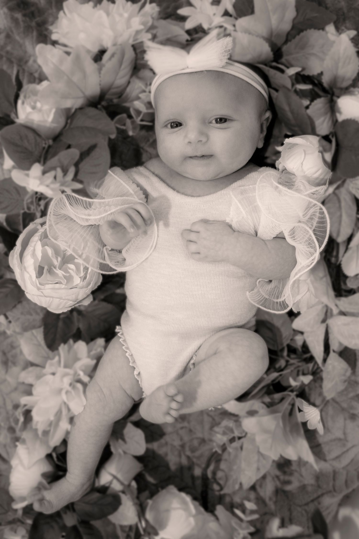 Newborn photographer Savannah GA, baby white outfit floral backdrop black white portrait — The Quiet Lens Studio
